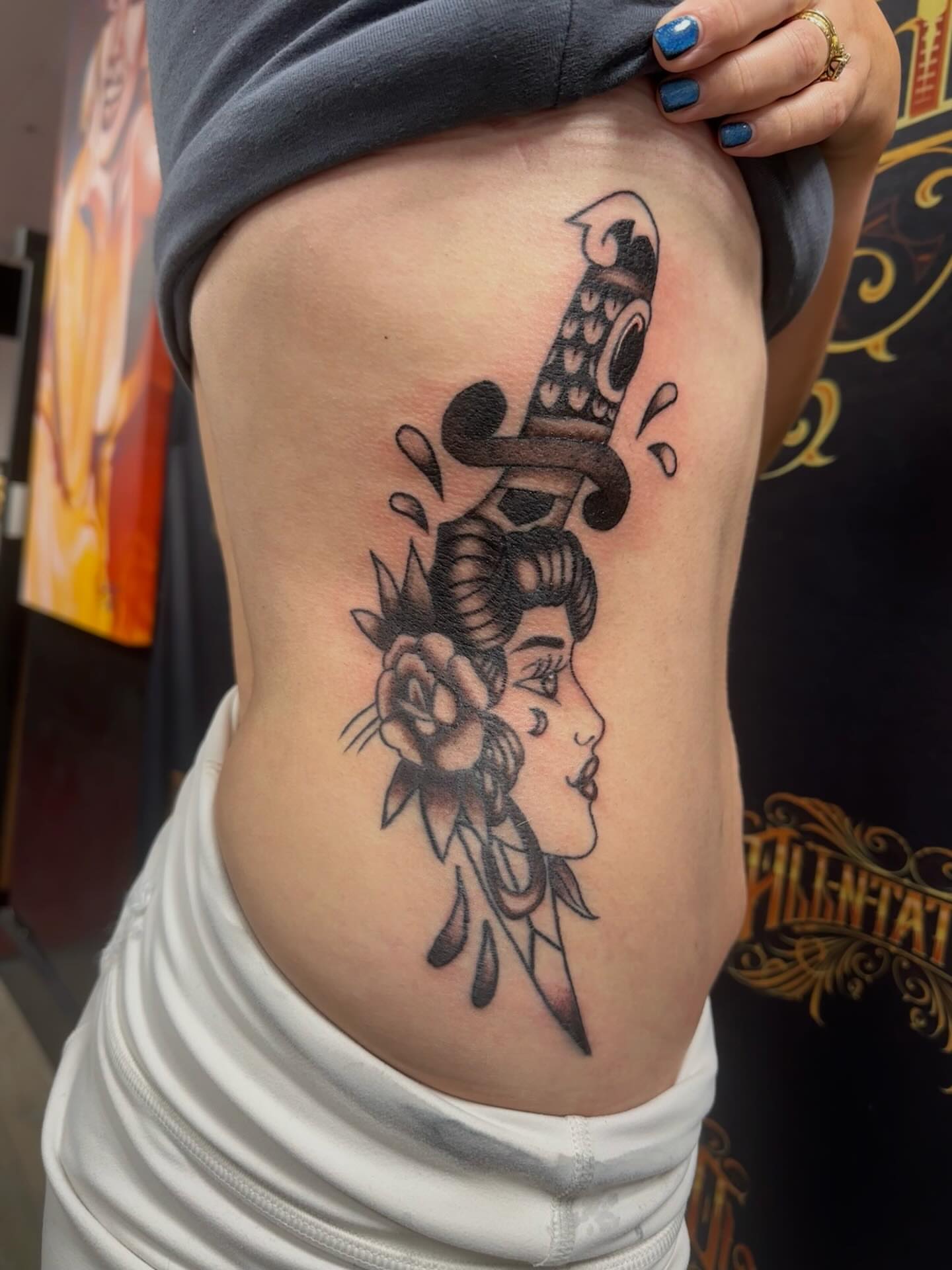 Woman with dagger American traditional tattoo on the ribs by Cherry Tats🍒