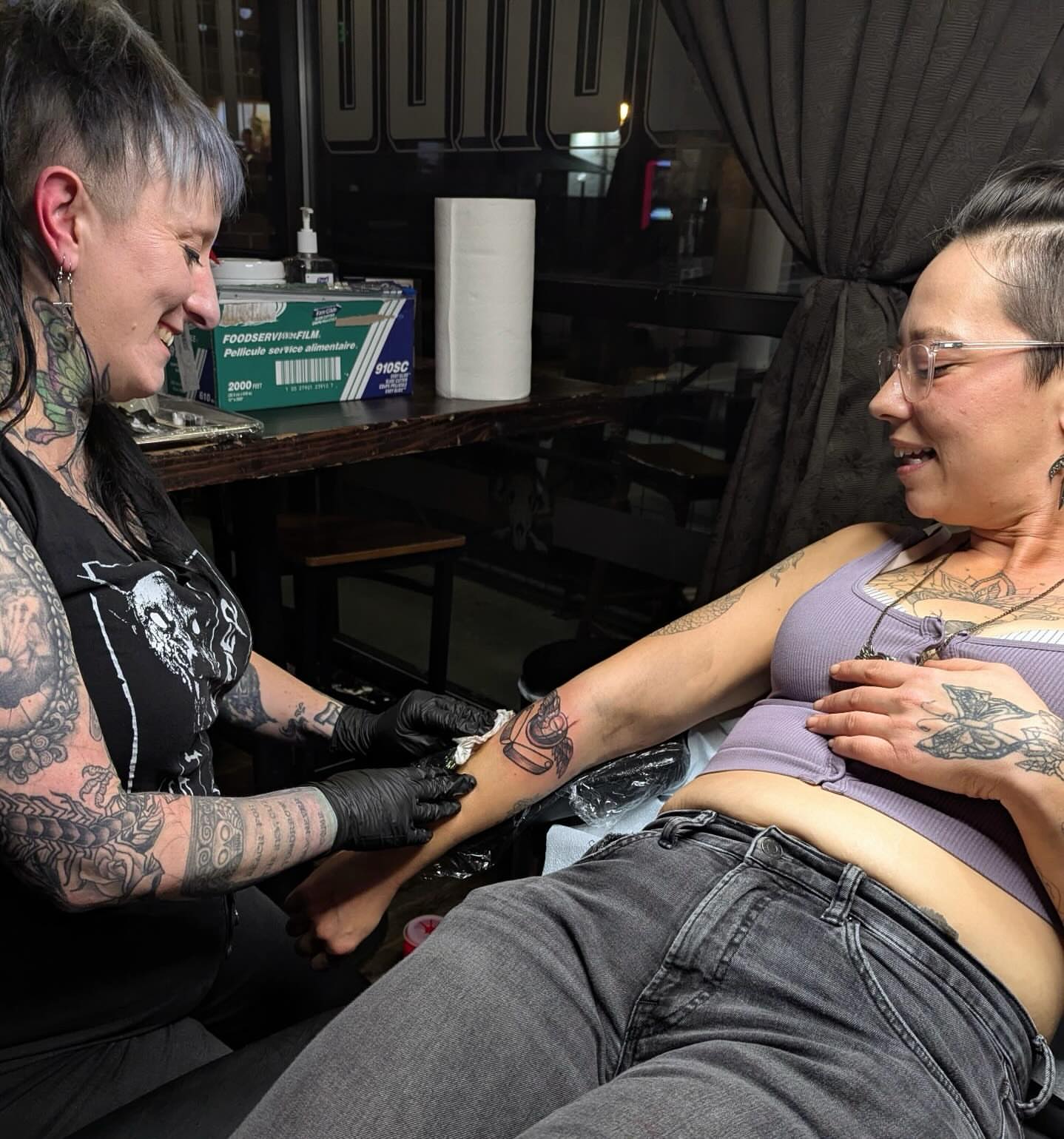 Tattoo artist and client American traditional tattoo on the upper arm by Misha Dumois, Seattle, Washington
