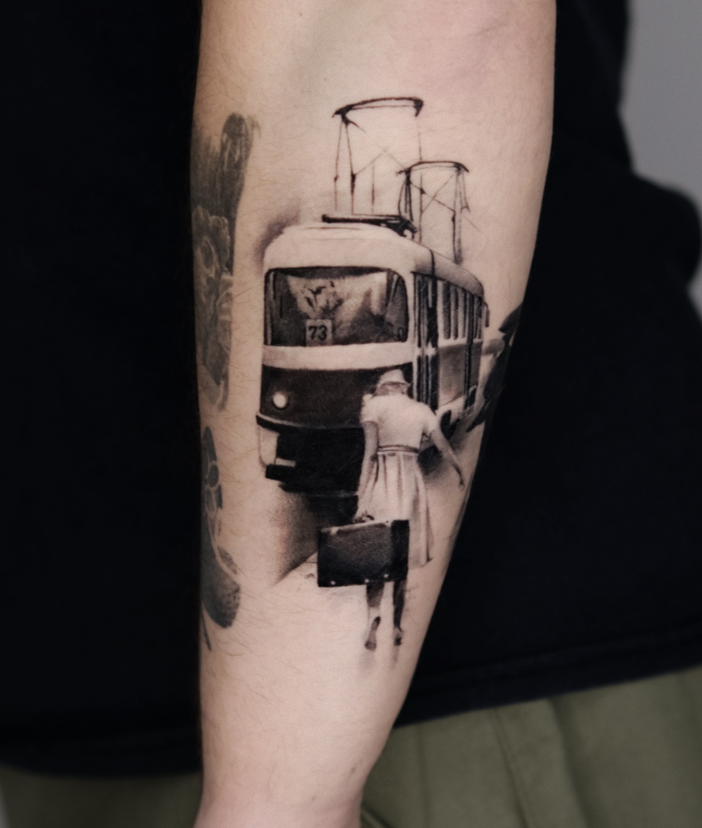 Tram and woman realism tattoo on the forearm by 𝐌𝐀𝐊𝐒𝐈𝐌 𝐏𝐀𝐓𝐑𝐈𝐂𝐊