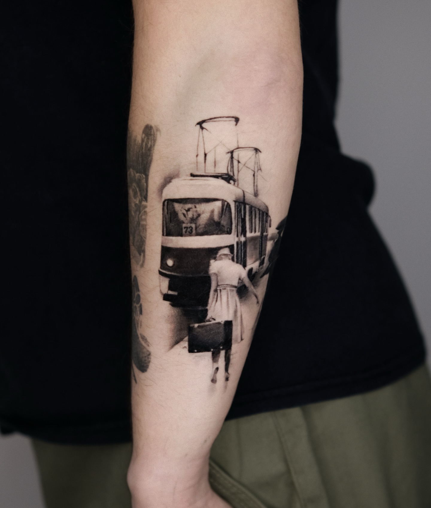 Tram and woman realism tattoo on the forearm by 𝐌𝐀𝐊𝐒𝐈𝐌 𝐏𝐀𝐓𝐑𝐈𝐂𝐊