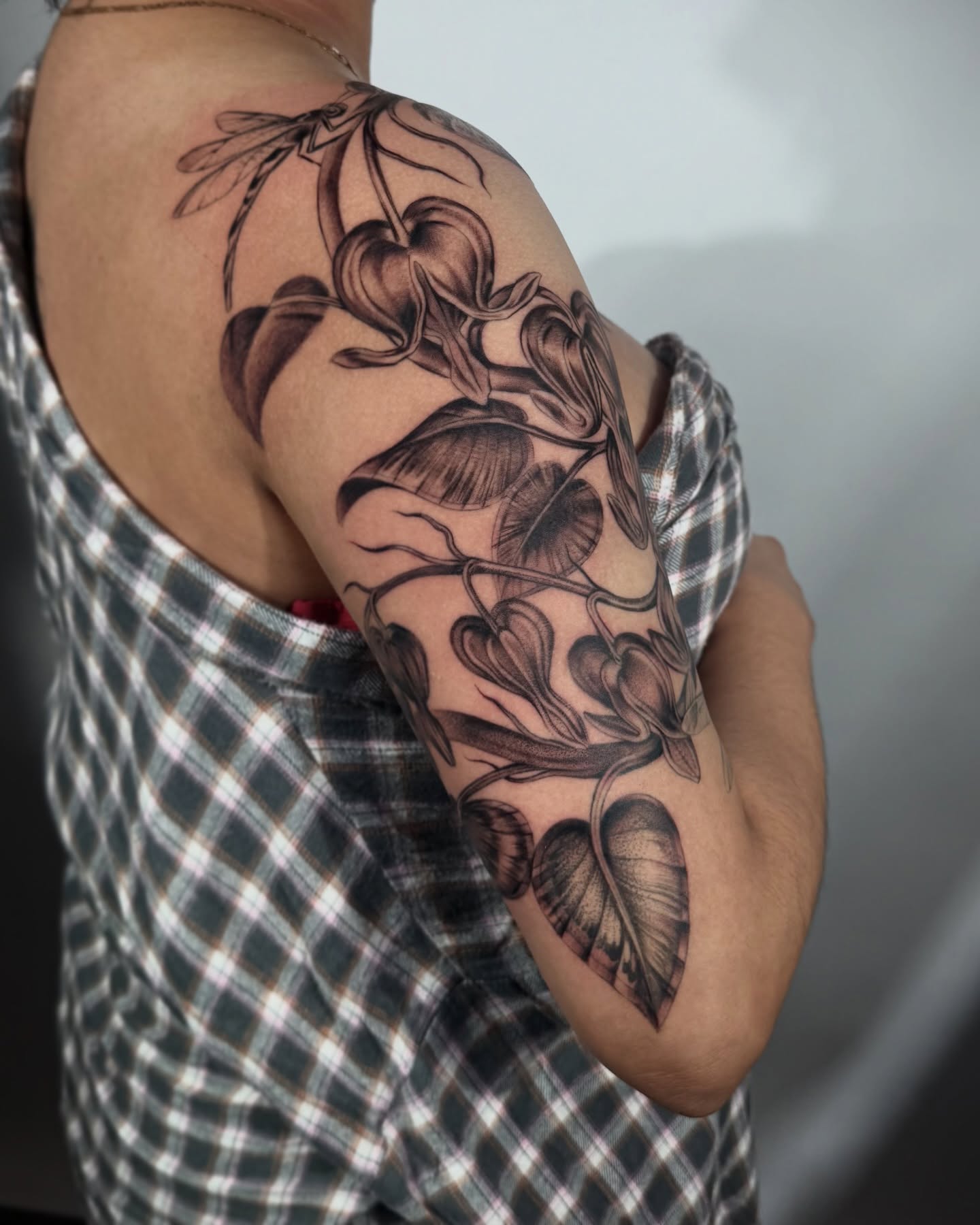 Lily black and grey tattoo on the upper arm by Tattoos.byDahlia, Austin, Texas
