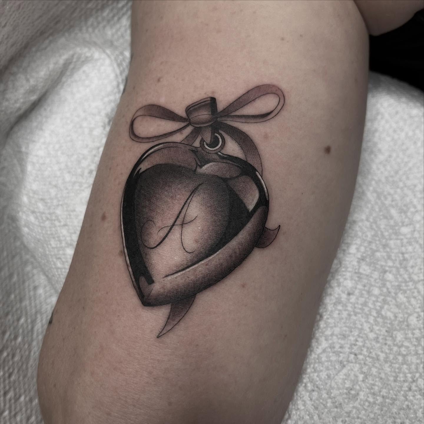 Heart ornament black and grey tattoo on the forearm by Kayla Faircloth, Charlotte, North Carolina