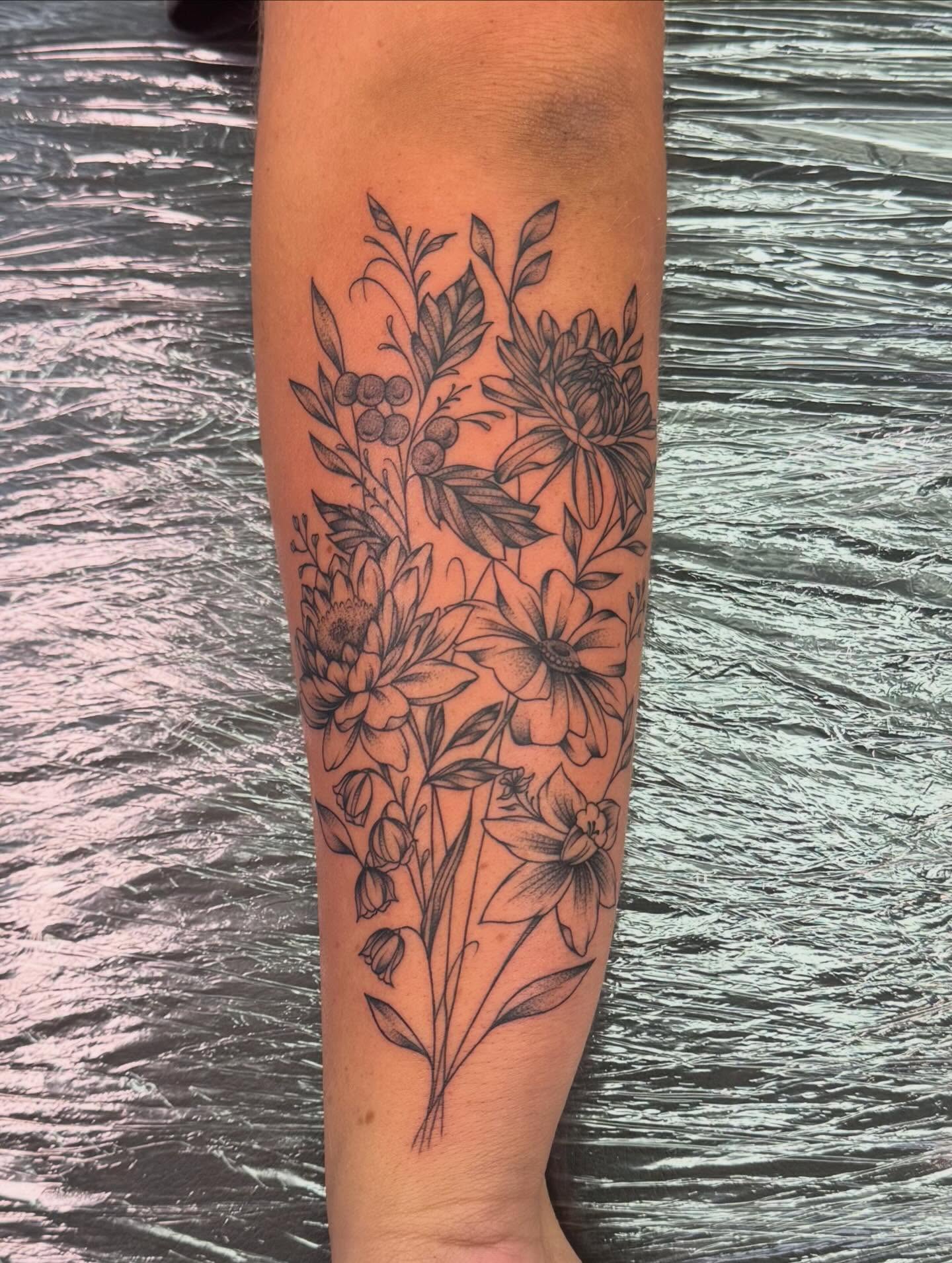 Floral arrangement black and grey tattoo on the forearm by haylie