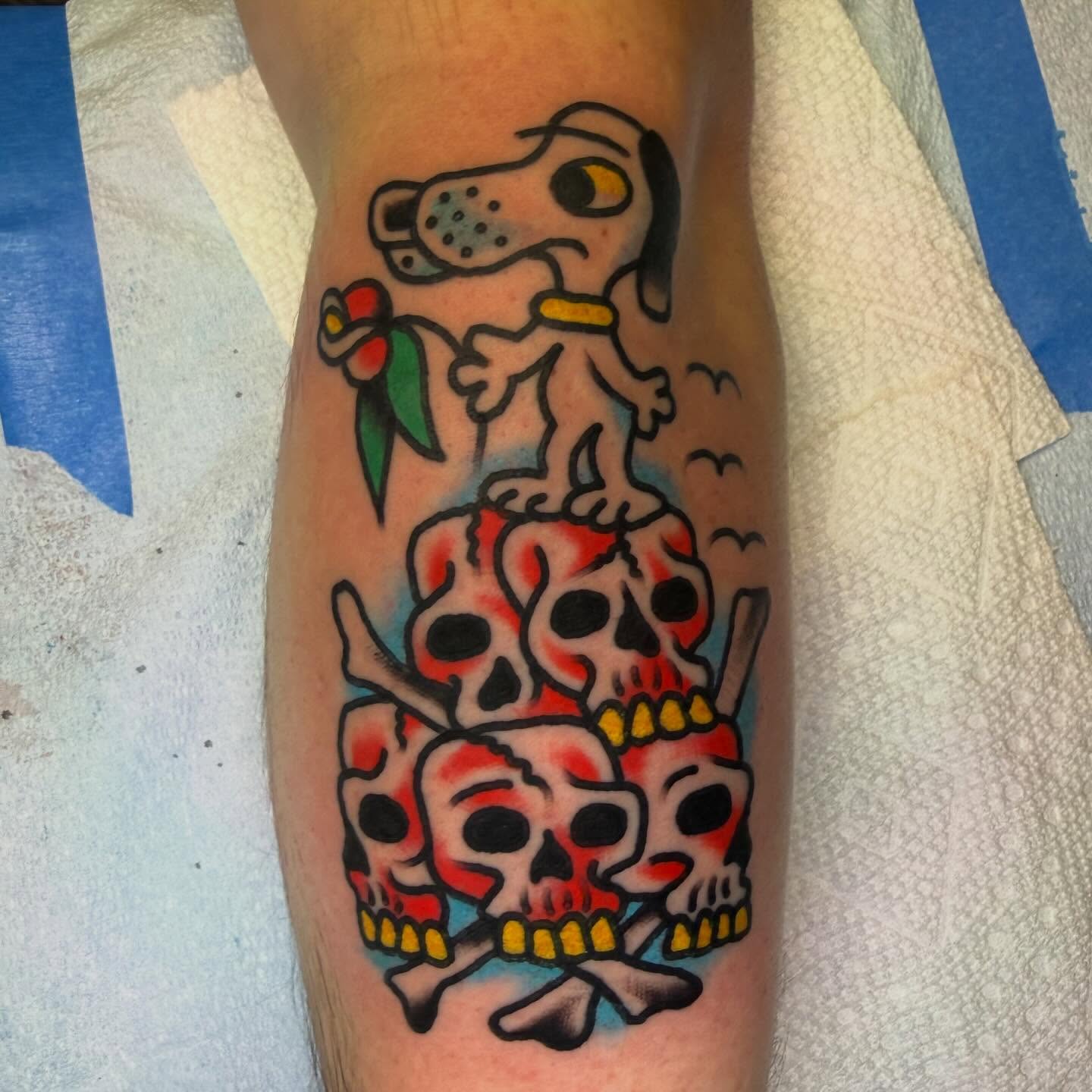 Dog and skulls American traditional tattoo on the forearm by Tyler