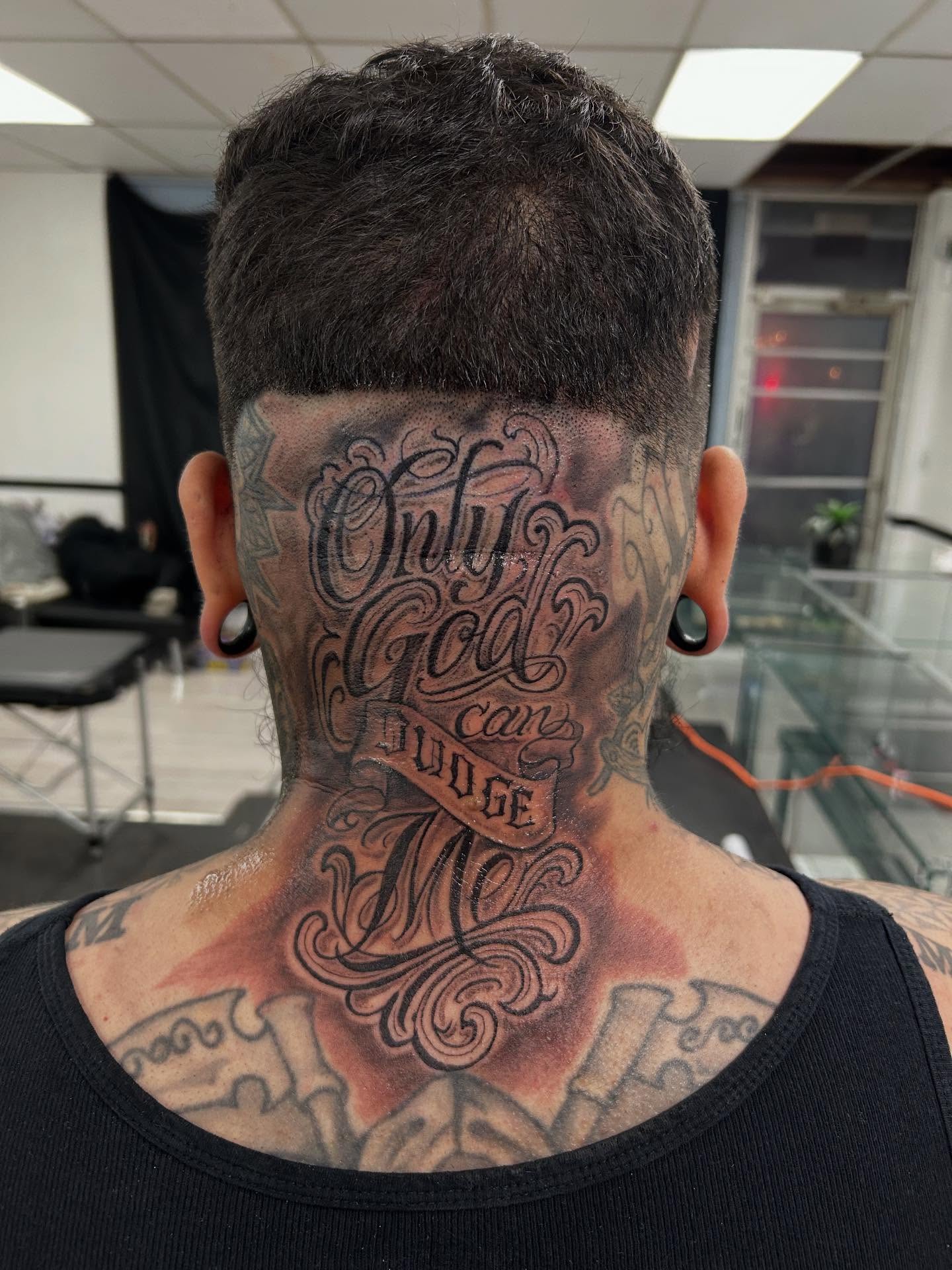 Only God can judge me lettering script tattoo on the neck by Cyko Hernandez