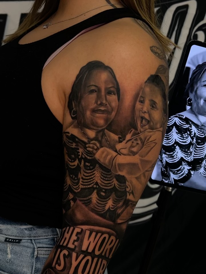 Portrait of woman and child realism tattoo on the upper arm by Daniel Michael Perez