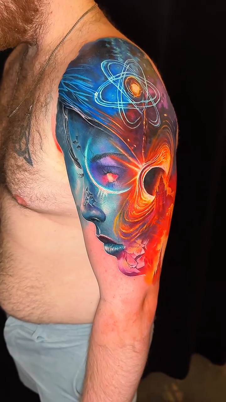 Cosmic woman with atom realism tattoo by Noelin Wheeler