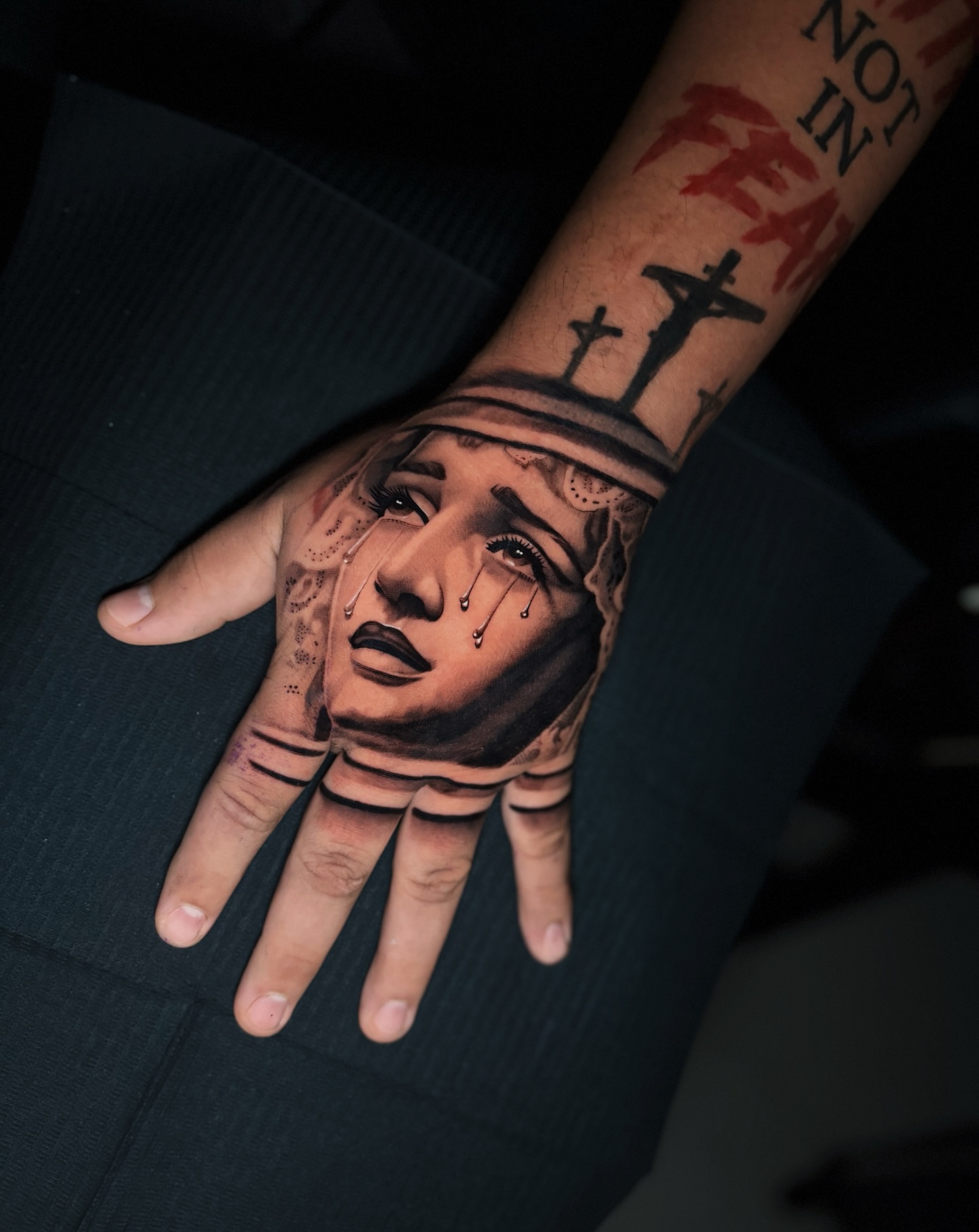Woman's face realism tattoo on the hand by Crooks Ink ✞