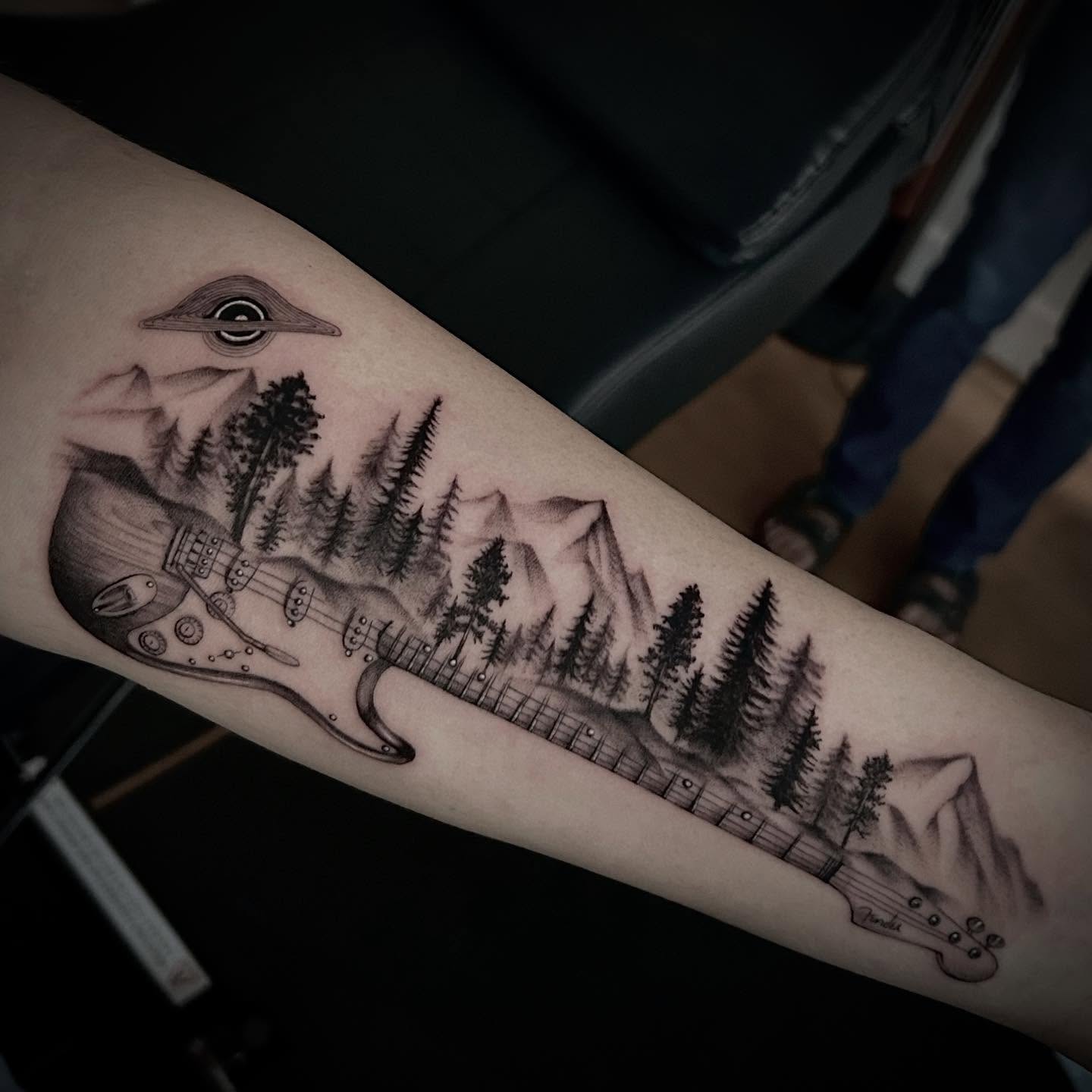 Guitar and forest realism tattoo on the forearm by Jonny Tattoo PHX AZ