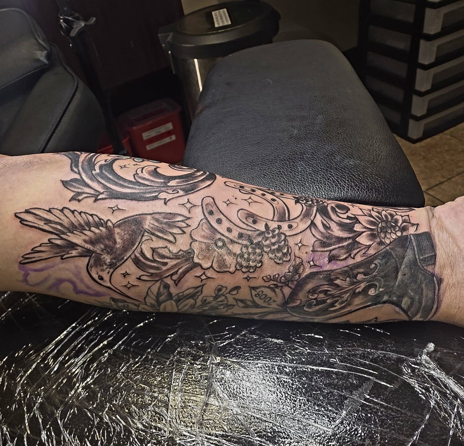 Bird and floral American traditional tattoo on the forearm by Jessica DarkRabbit