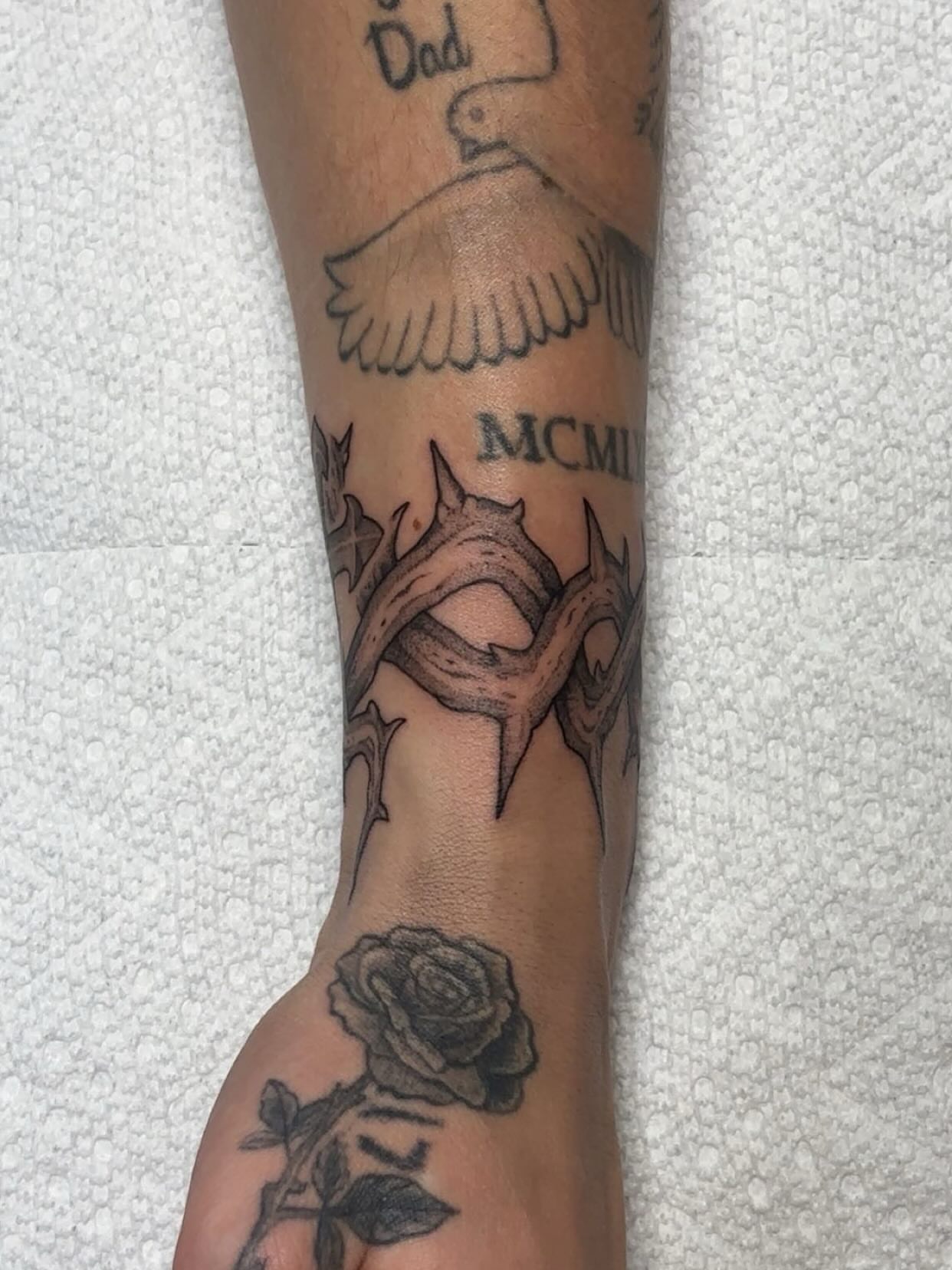 Rose and thorns black and grey tattoo on the forearm by Izabelle Inks