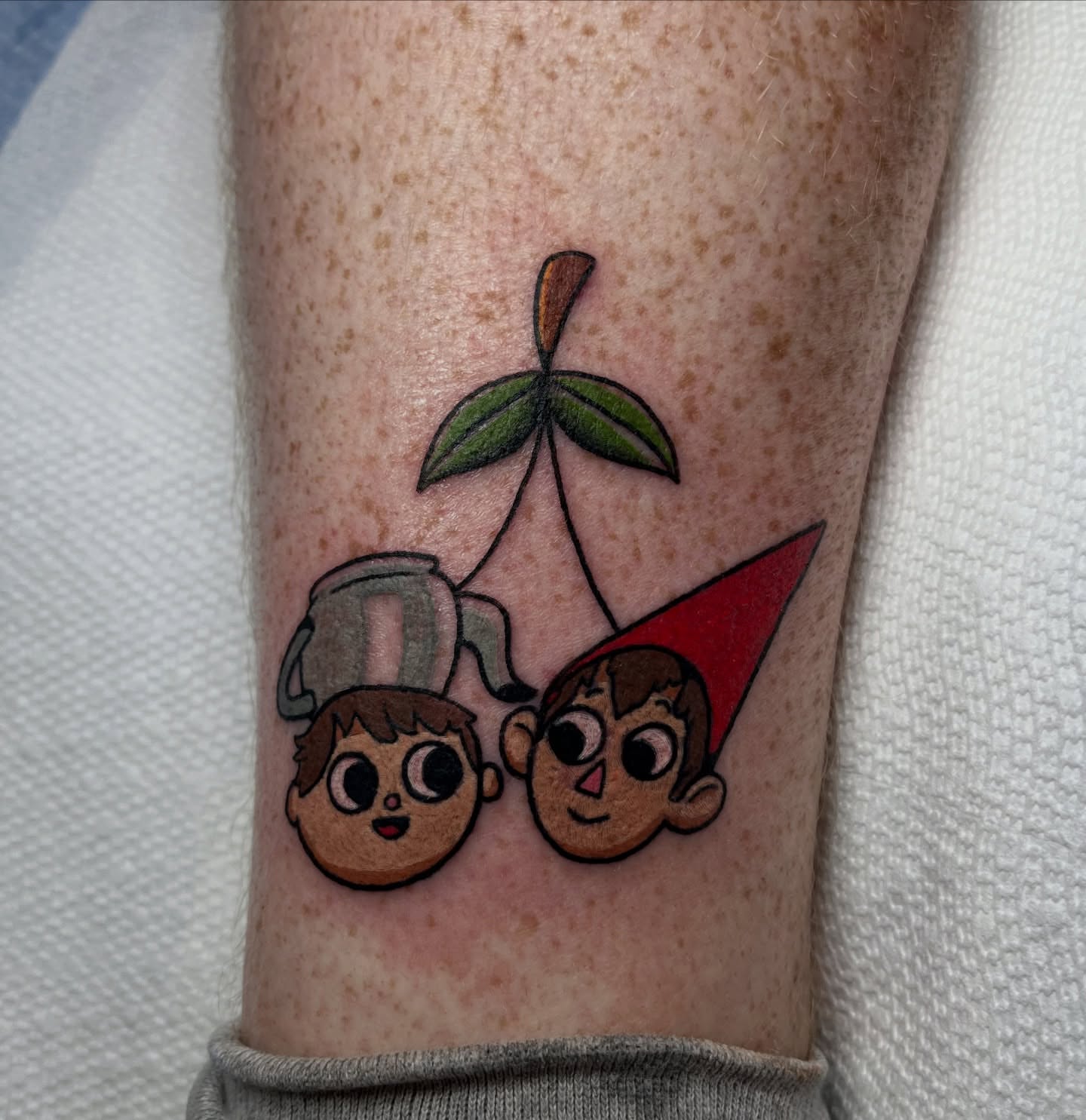 Cherry and characters dotwork tattoo on the forearm by Alena McDonald