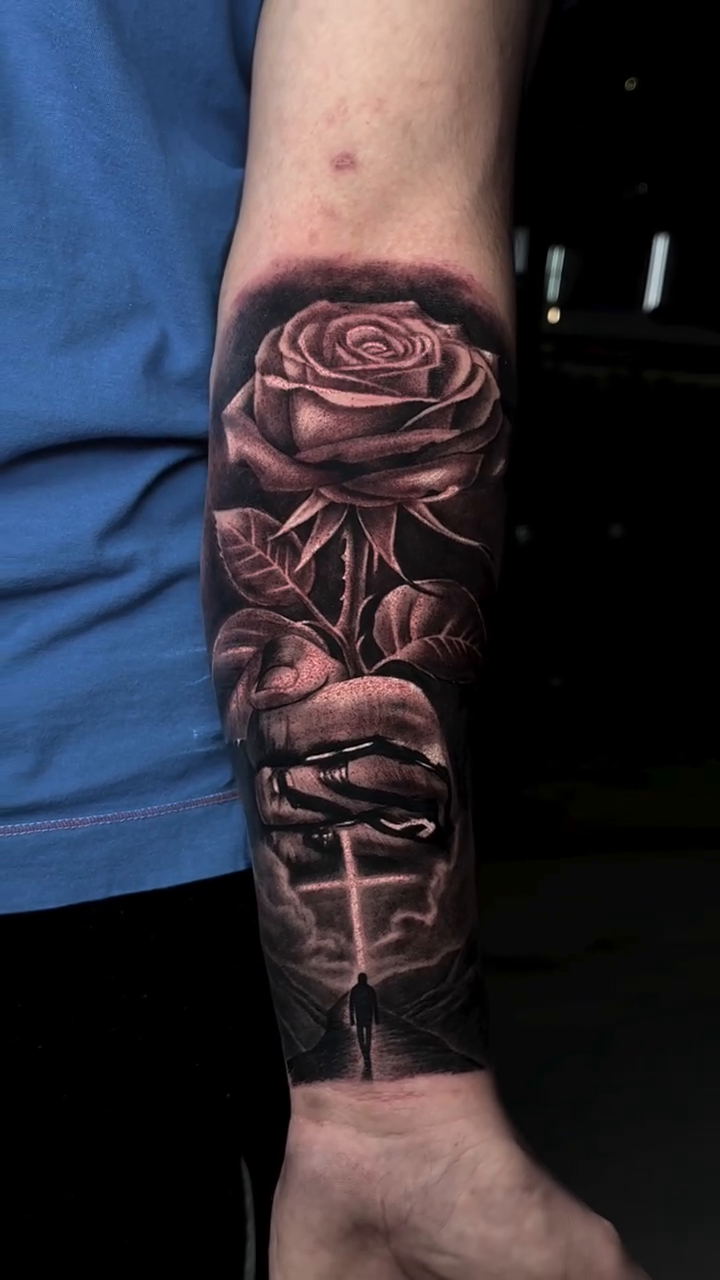 Rose and cross with figure realism tattoo by Michael Sosa
