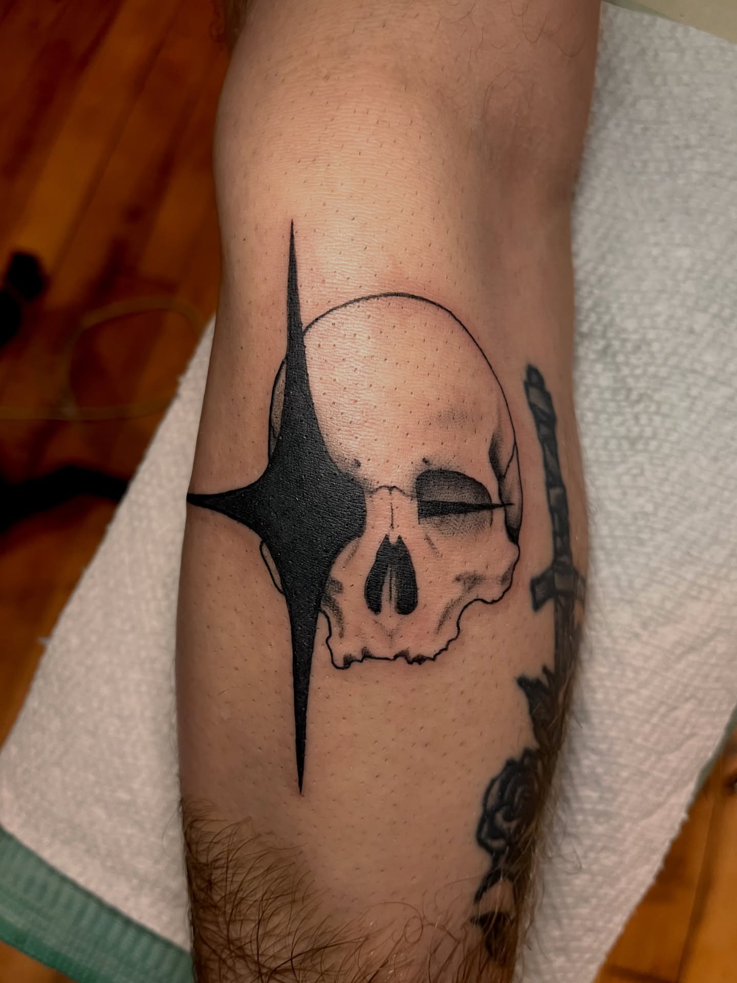 Skull with star black and grey tattoo on the forearm by Zoe Phan, Richmond, Virginia