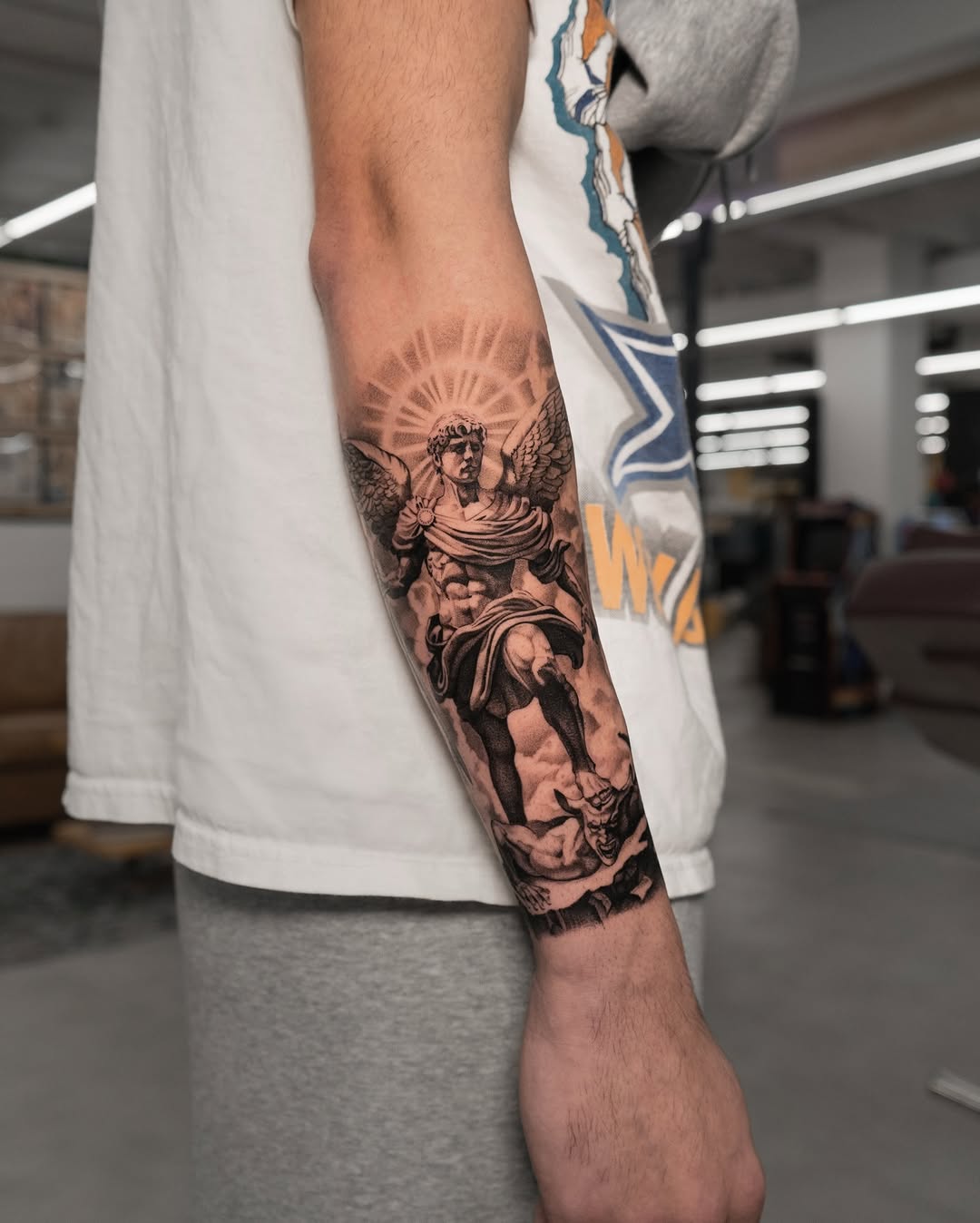 Archangel Michael defeating the devil realism tattoo on the forearm by Mateo