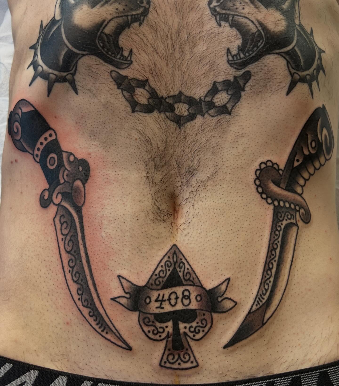 Sword and wolf American traditional tattoo on the torso by Mikey Montoya