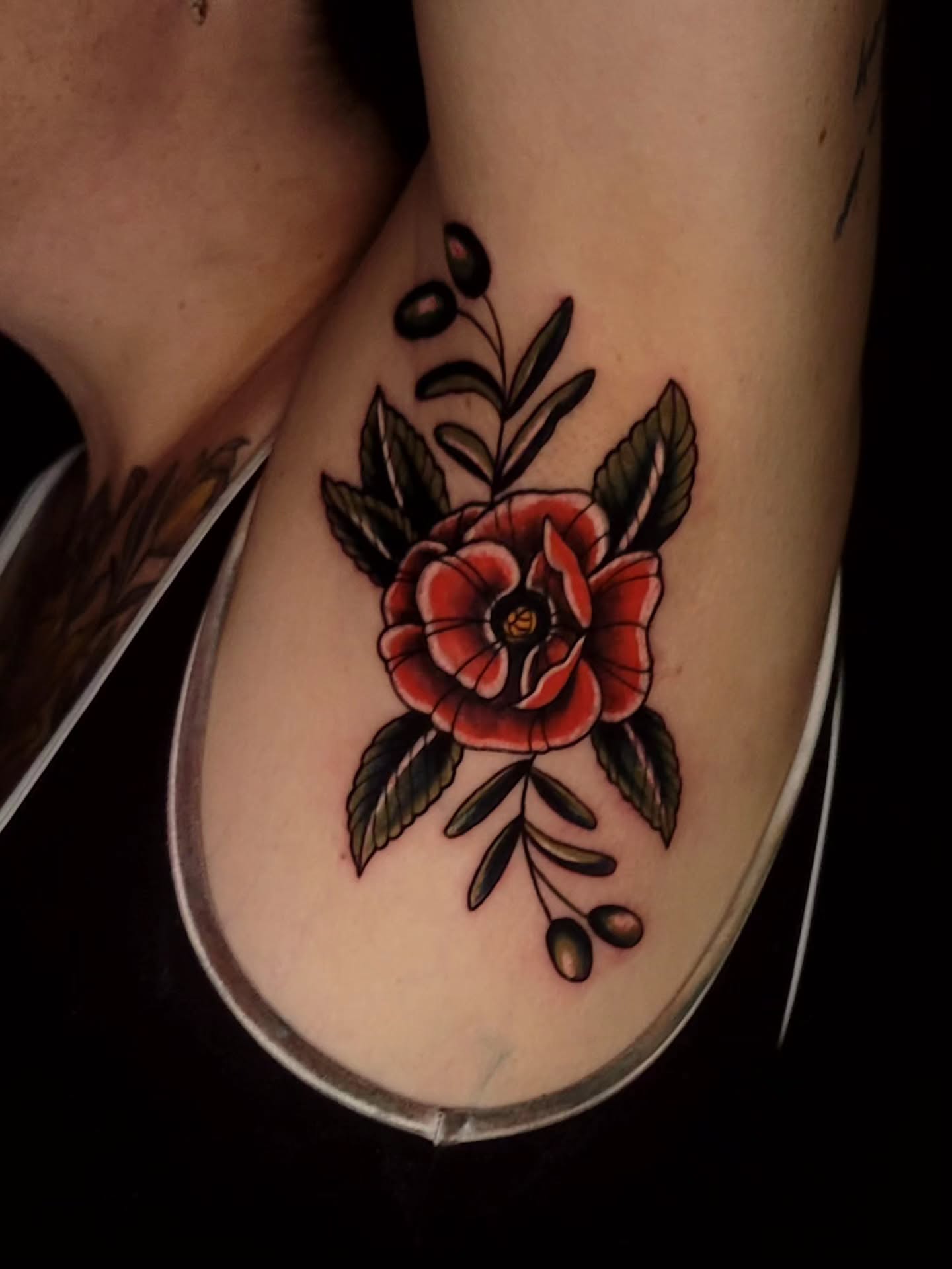 Red rose American traditional tattoo on the thigh by Tyler Monty