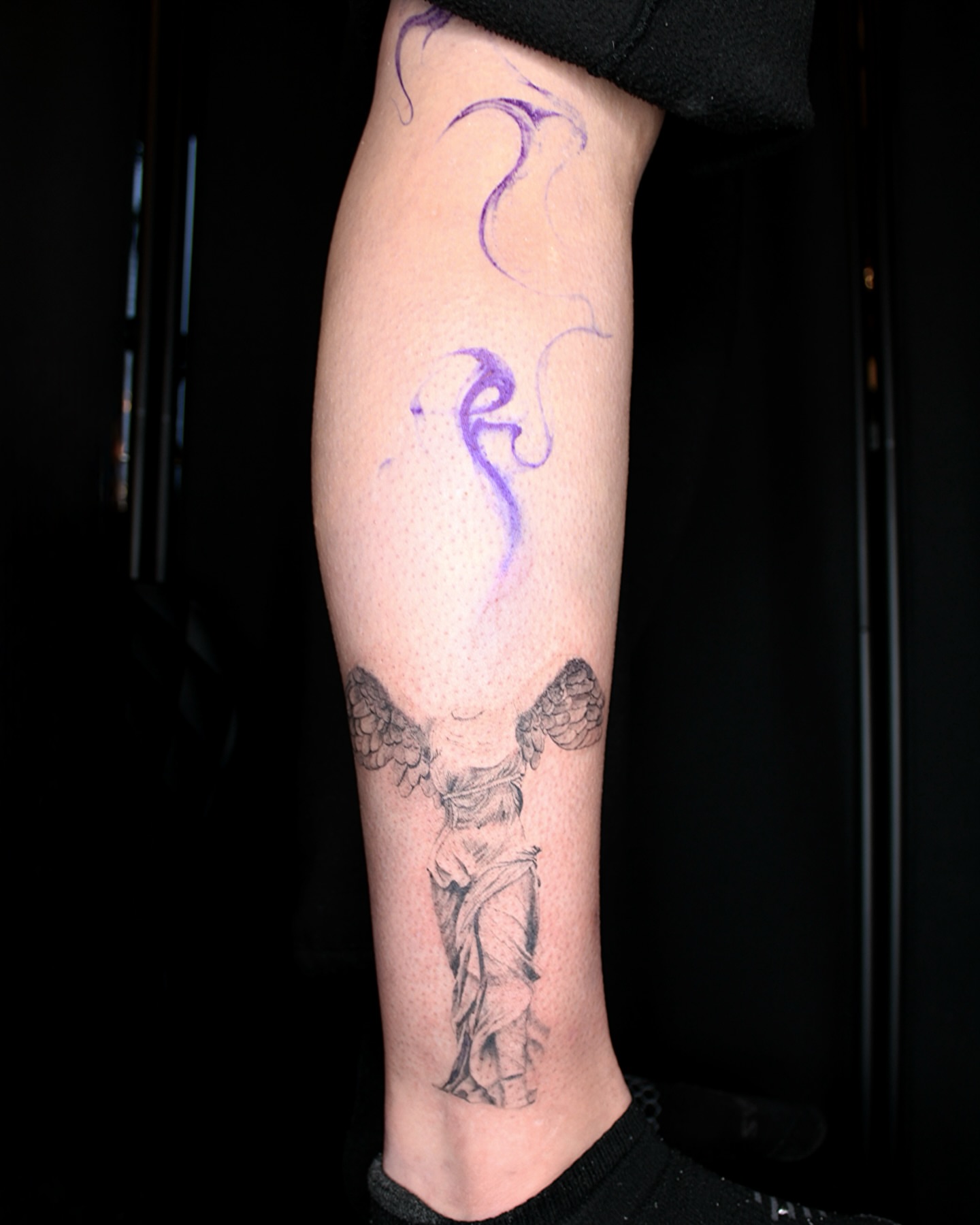 Statue with wings black and grey tattoo on the forearm by ππ²π§π§ ππ’π₯πππ« (π©π¦