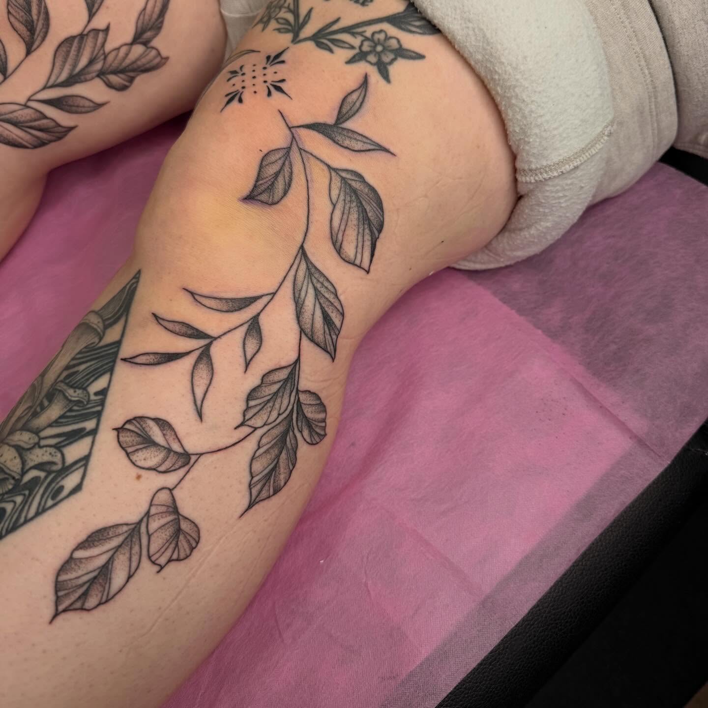 Leafy branch black and grey tattoo on the forearm by Erica Rose π€