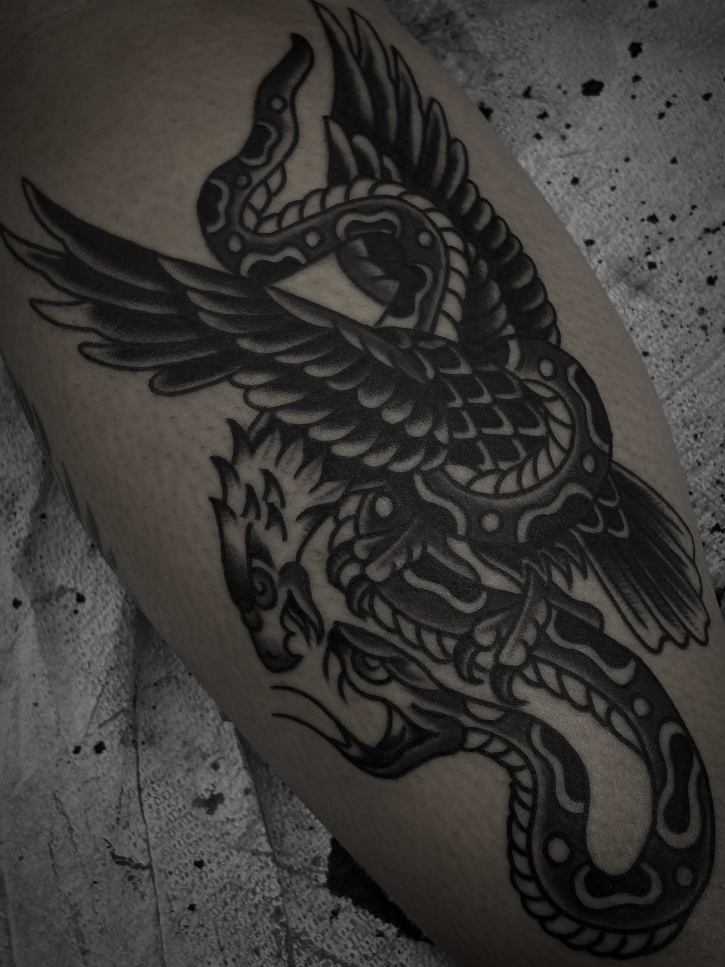 Winged dragon black and grey tattoo on the thigh by Carlos Gonzalez Tattoo, Dallas, Texas