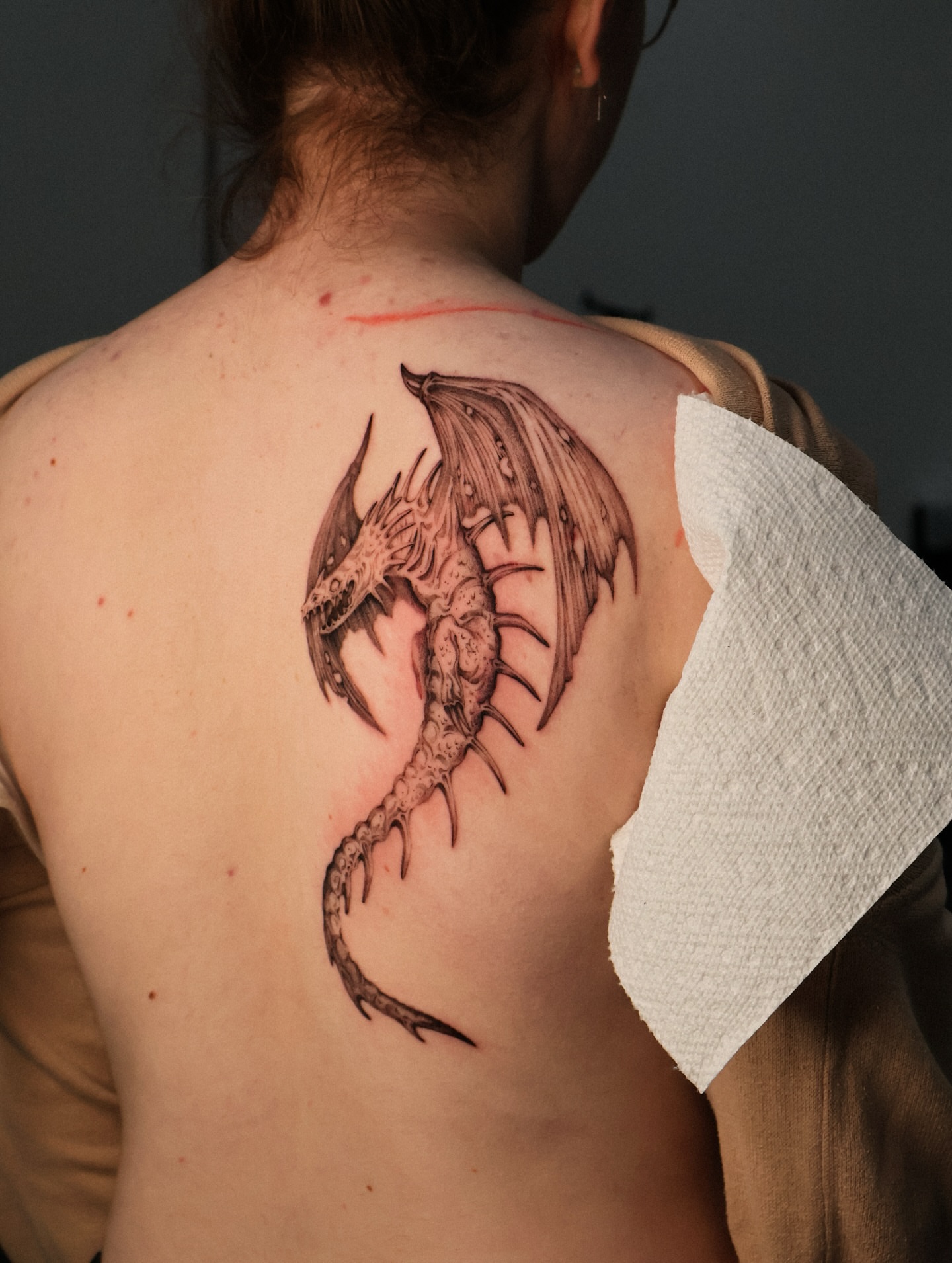 Dragon black and grey tattoo on the back by Grace Zarmina Hessam