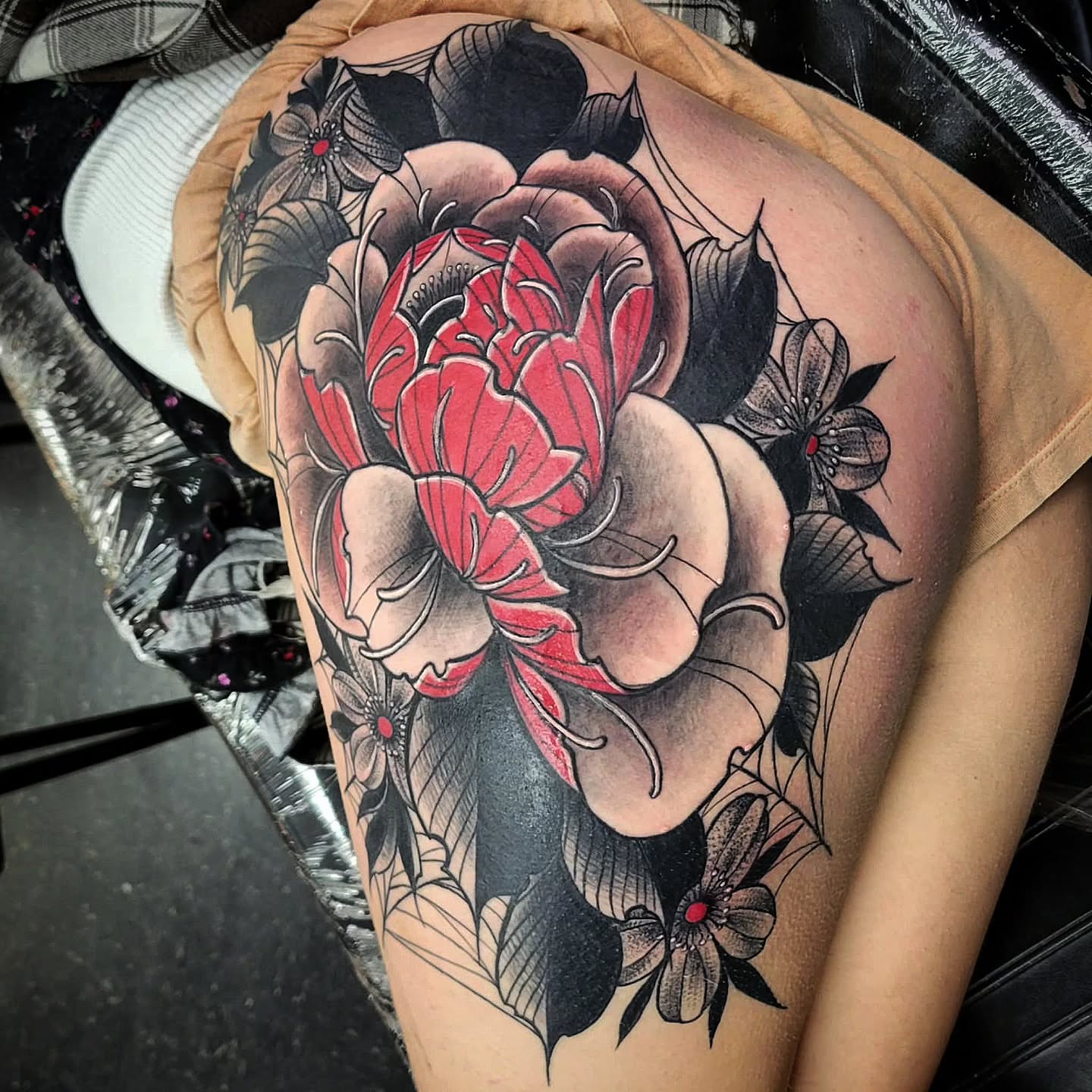 Peony American traditional tattoo on the thigh by Barrett Handel
