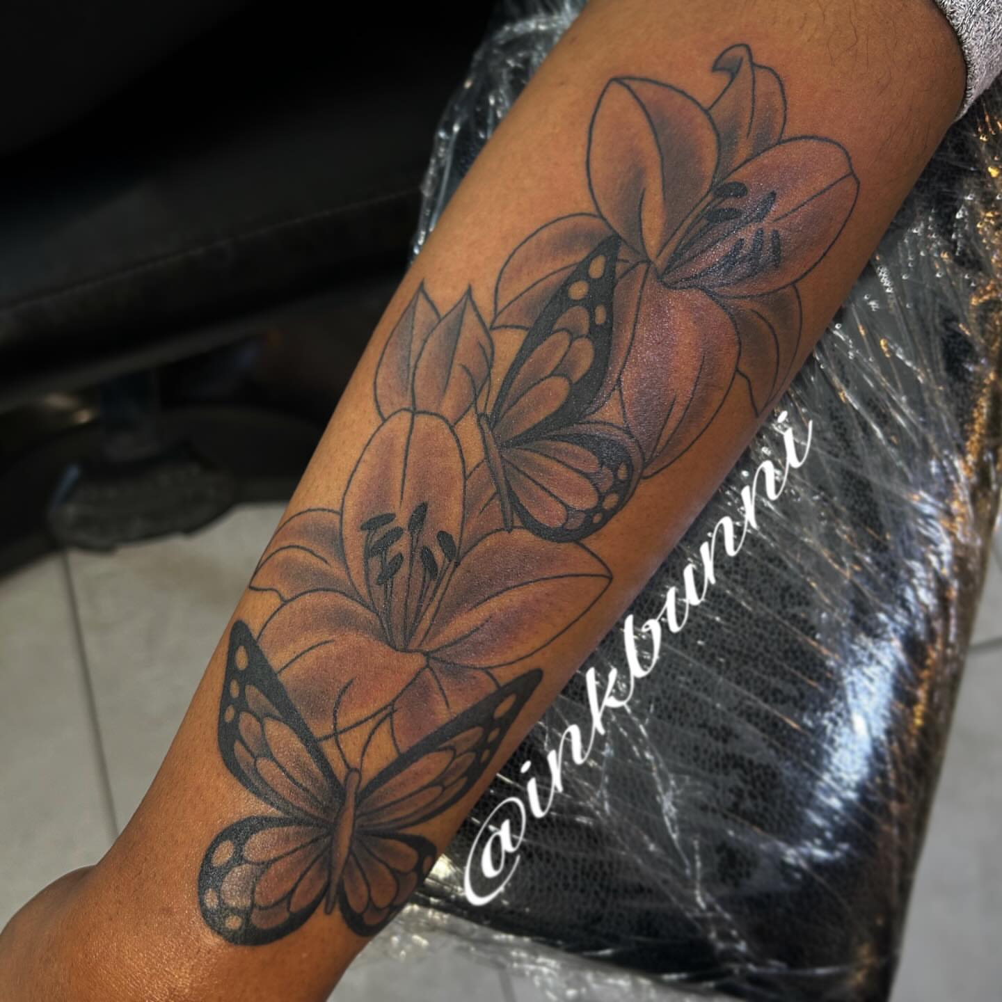 Lilies and butterflies black and grey tattoo on the forearm by Hailey Aka inkbunni, Detroit, Michigan
