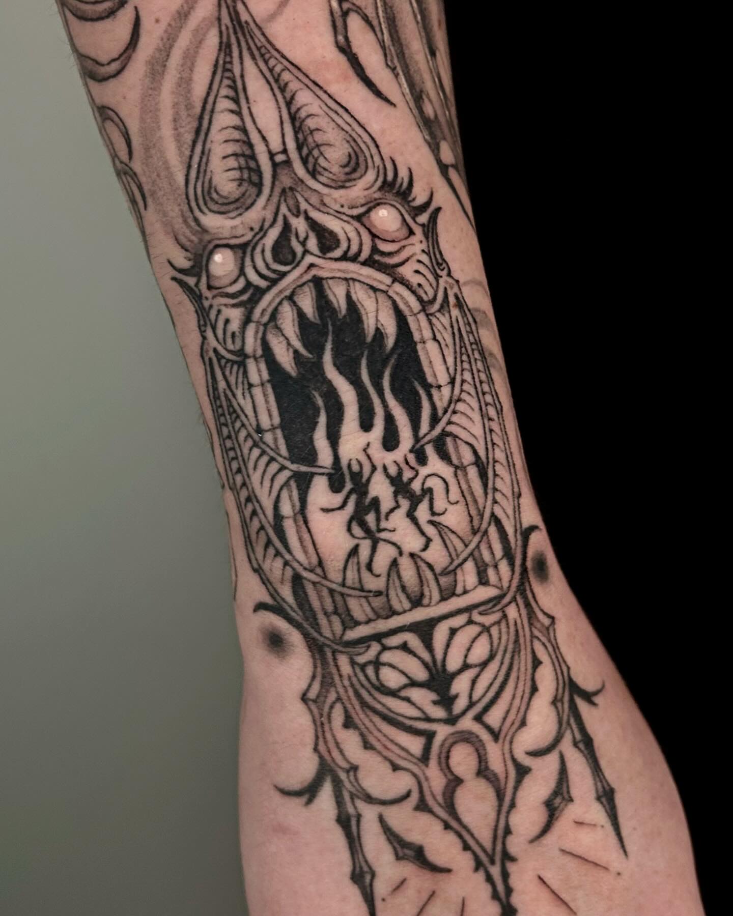 Demon dark realism tattoo on the forearm by 𝔅𝔢𝔩𝔩𝔞