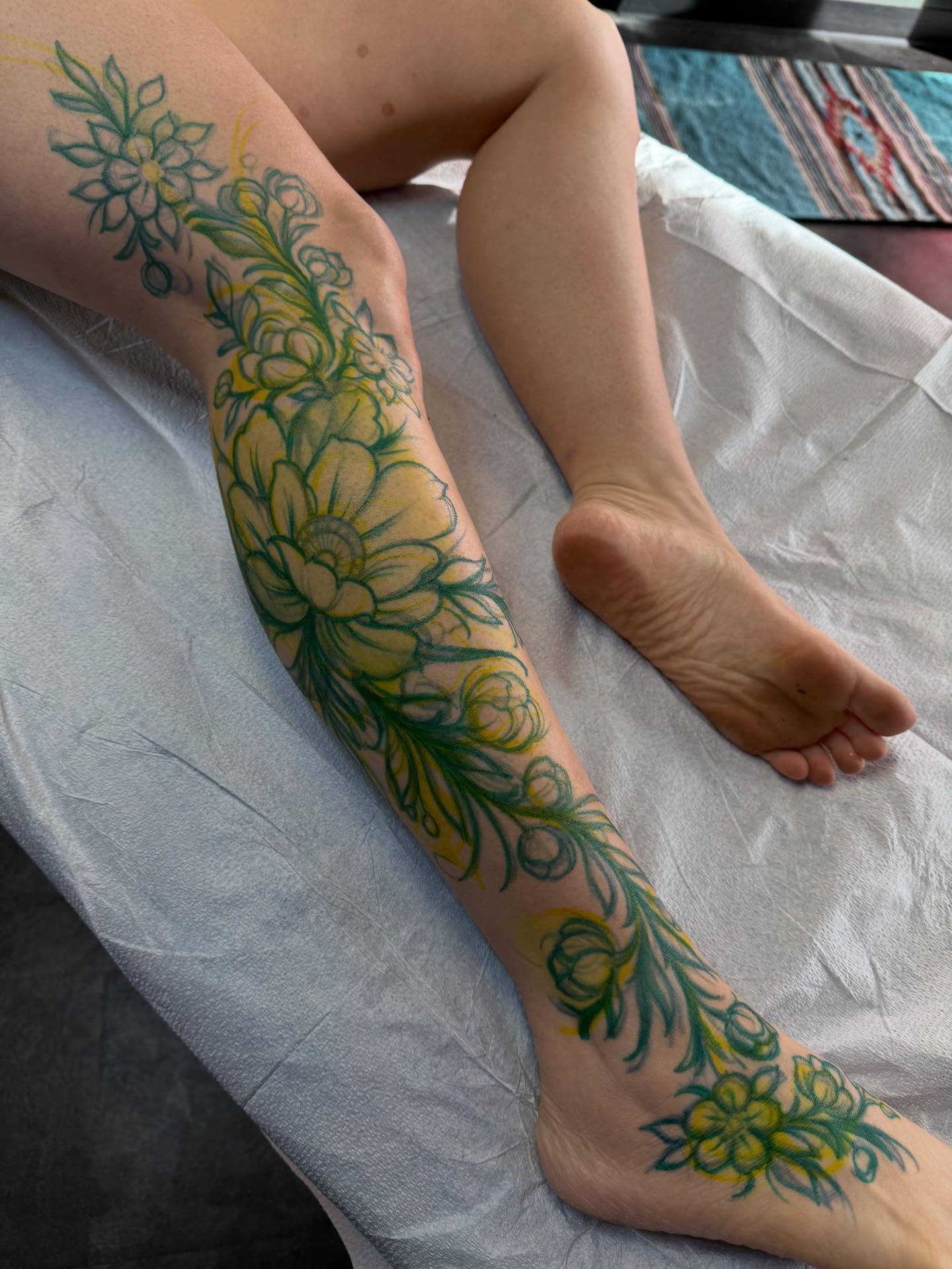 Floral design new school tattoo on the calf by Jason Lawyer