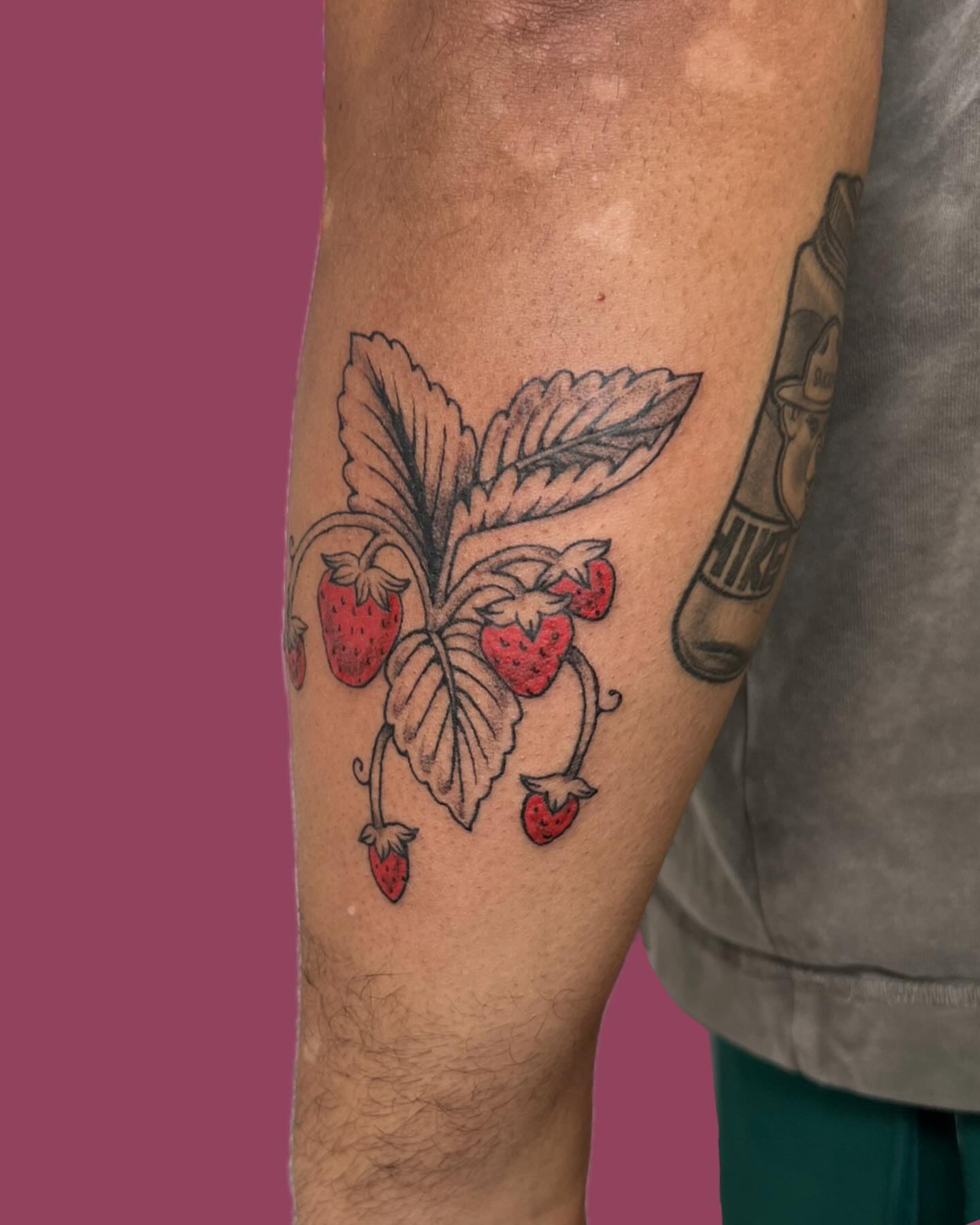 Strawberries realism tattoo on the forearm by rachel