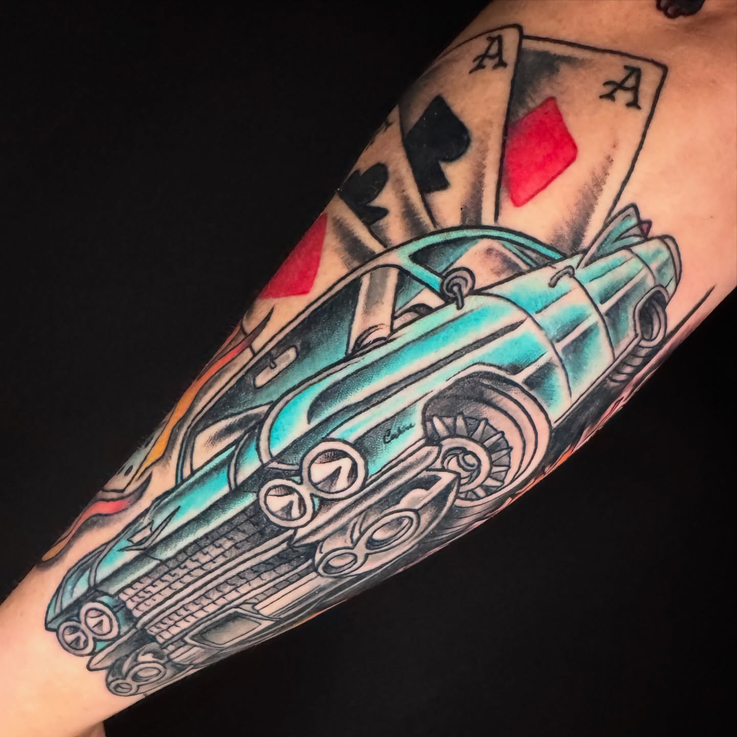 Classic car and playing card American traditional tattoo on the forearm by Cary Aldridge