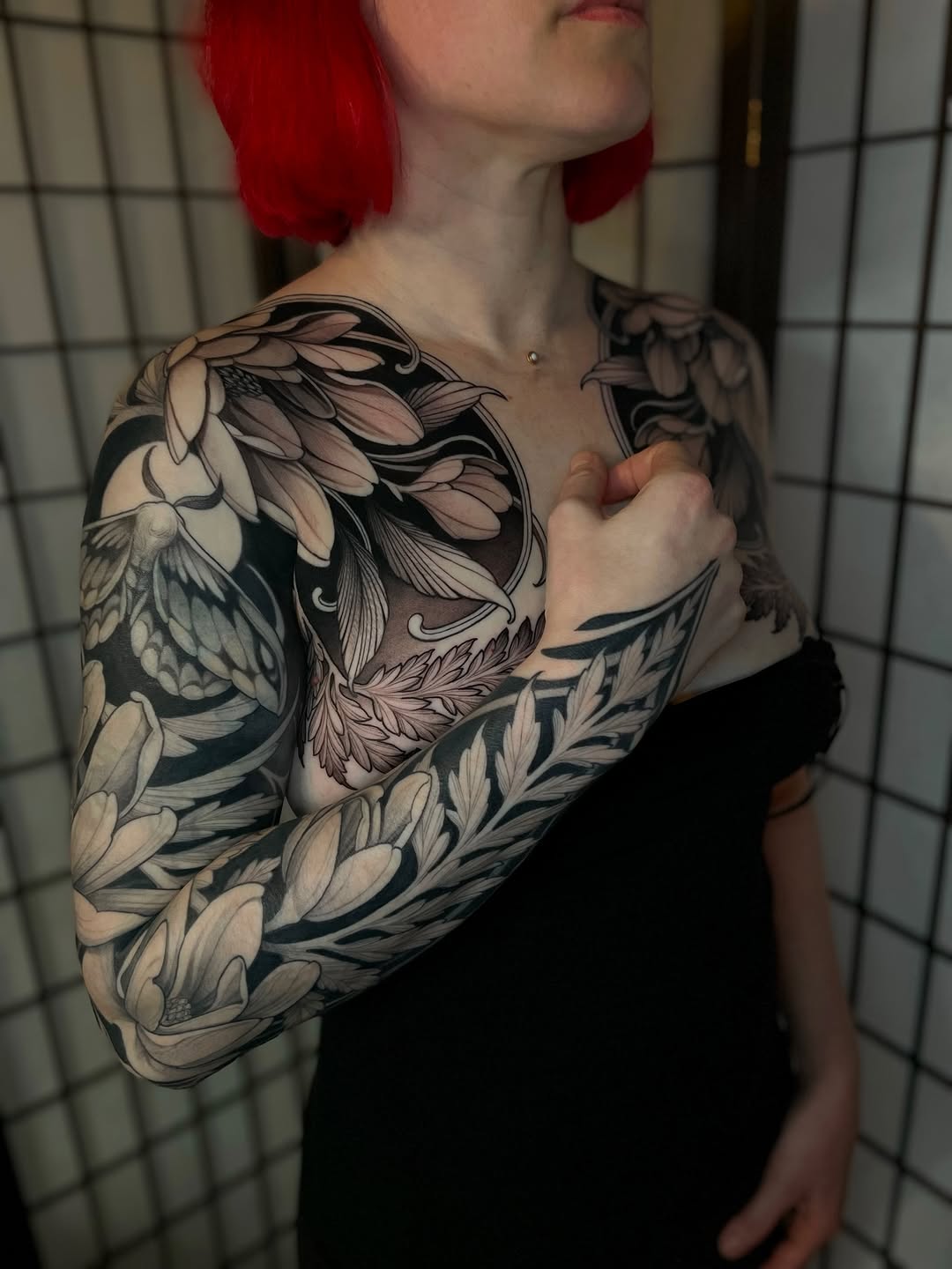 Floral and moth Japanese tattoo on the upper arm by Madelyn Roberts, Bellingham, Washington
