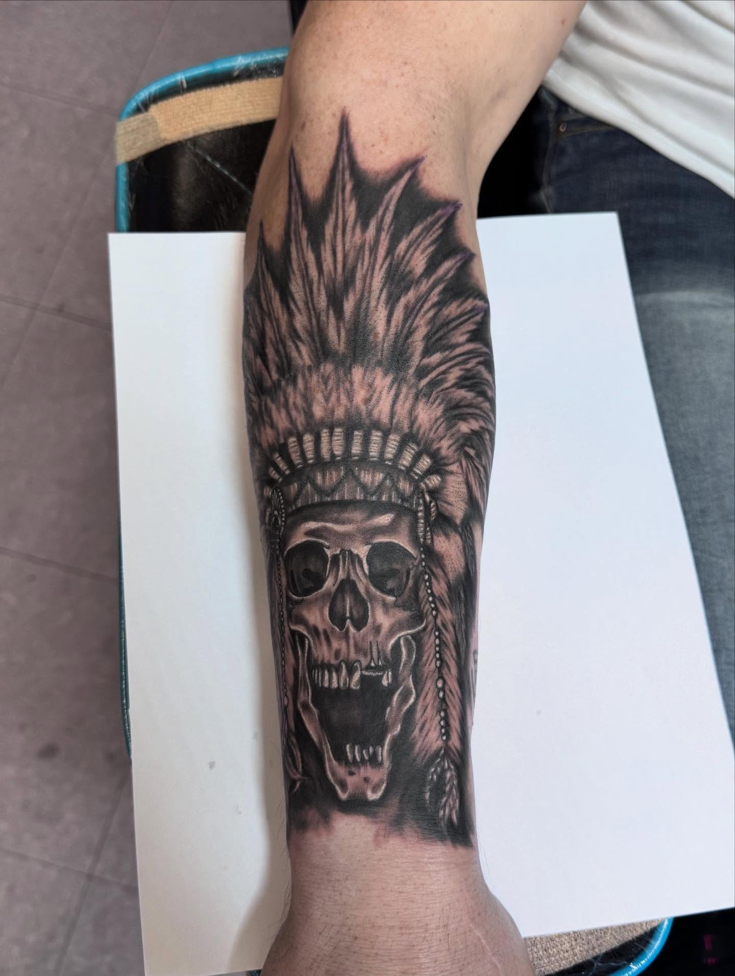 Skull with headdress realism tattoo on the forearm by Jacob - Tattoo Artist