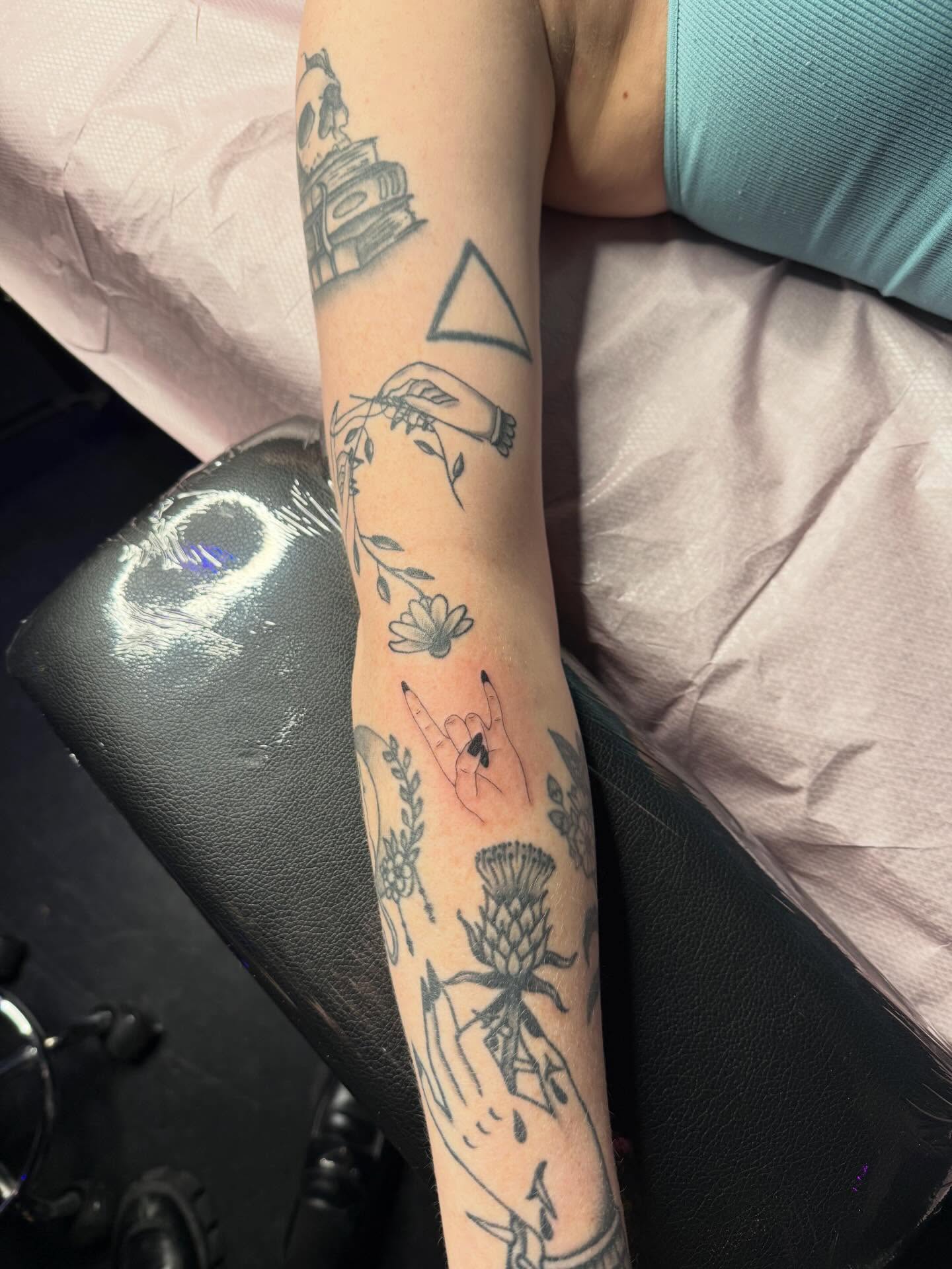 Floral and hand motifs black and grey tattoo on the forearm by Simba Nguyen
