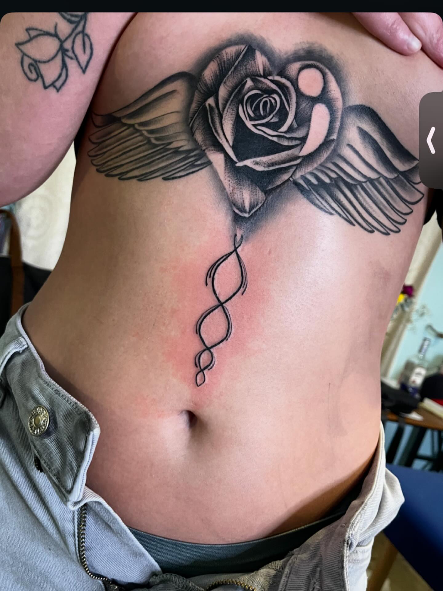 Winged rose black and grey tattoo on the ribs by Las Vegas Tattoo Artist