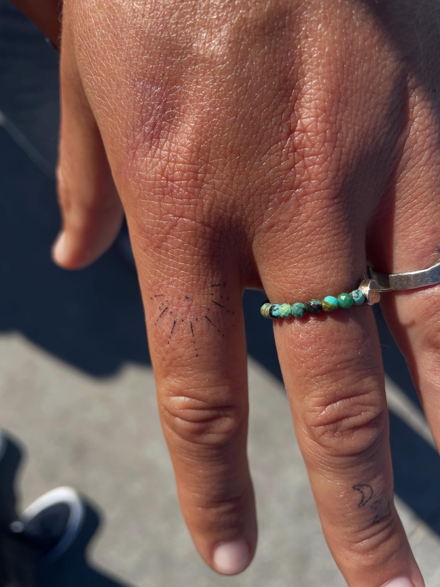 Sunburst dotwork tattoo on the hand by Alyssa