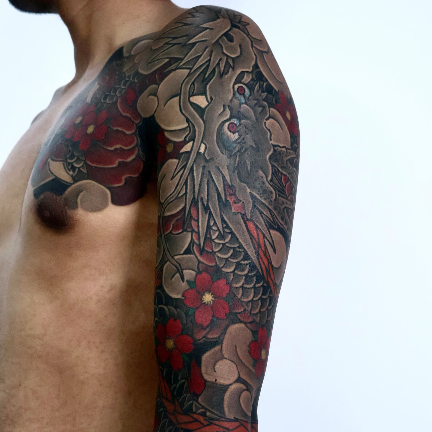 Dragon and flowers japanese irezumi tattoo on the upper arm by JM kim, Melbourne, Victoria