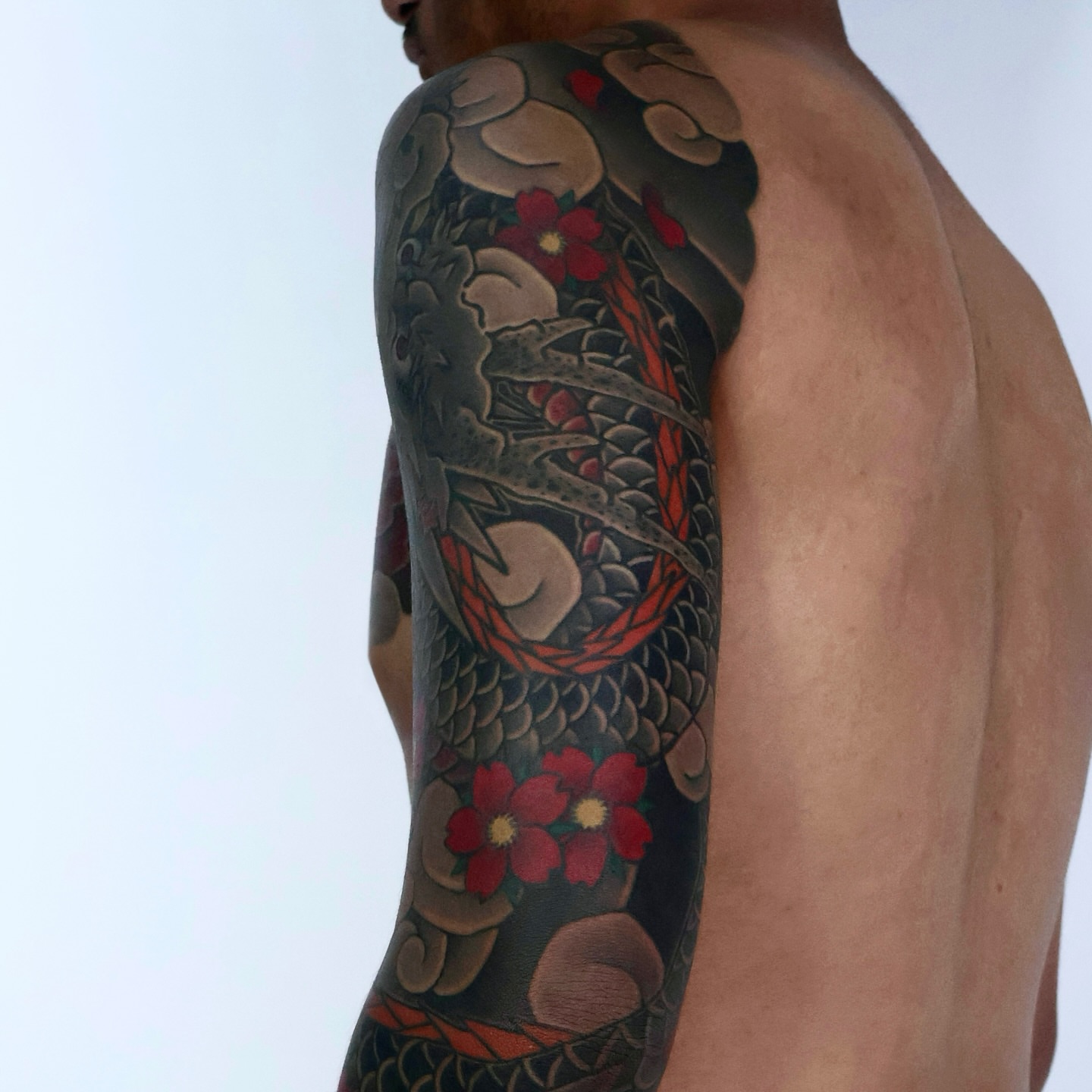 Dragon and flowers japanese irezumi tattoo on the upper arm by JM kim, Melbourne, Victoria