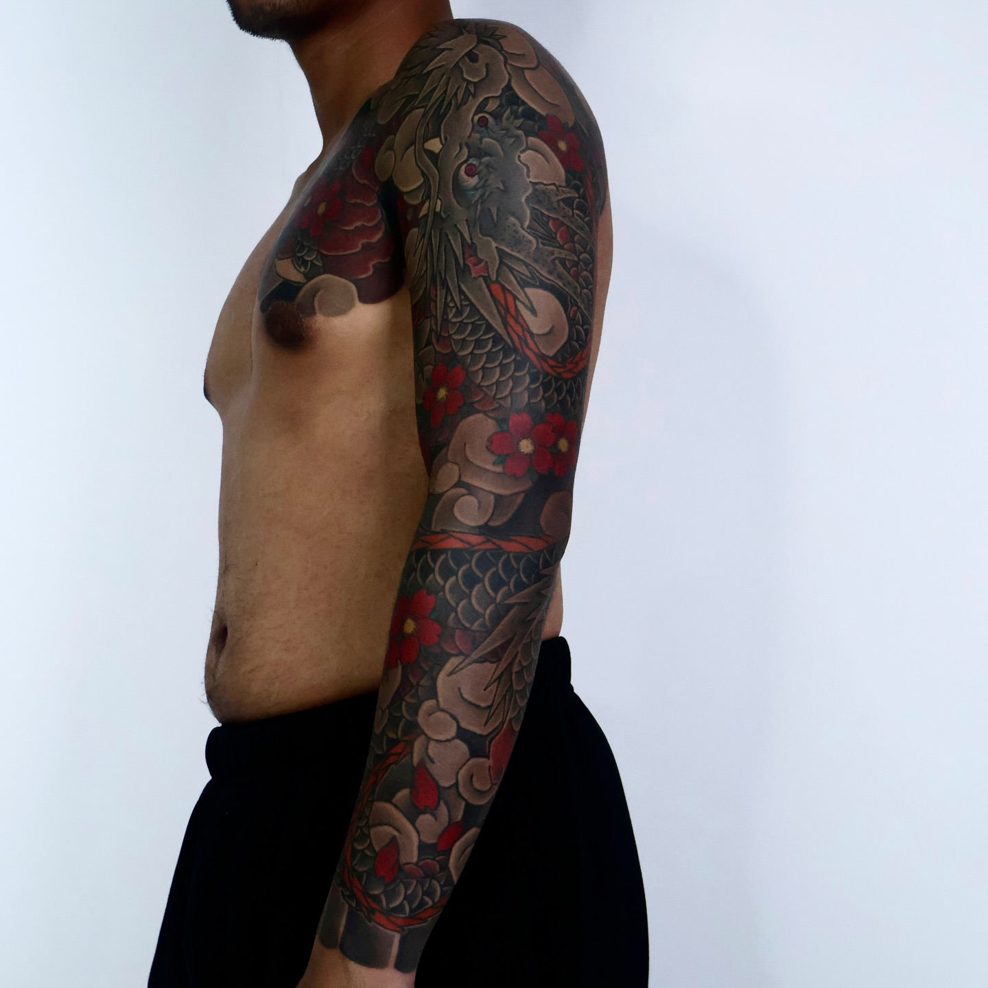 Koi fish and flowers japanese irezumi tattoo on the upper arm by JM kim, Melbourne, Victoria