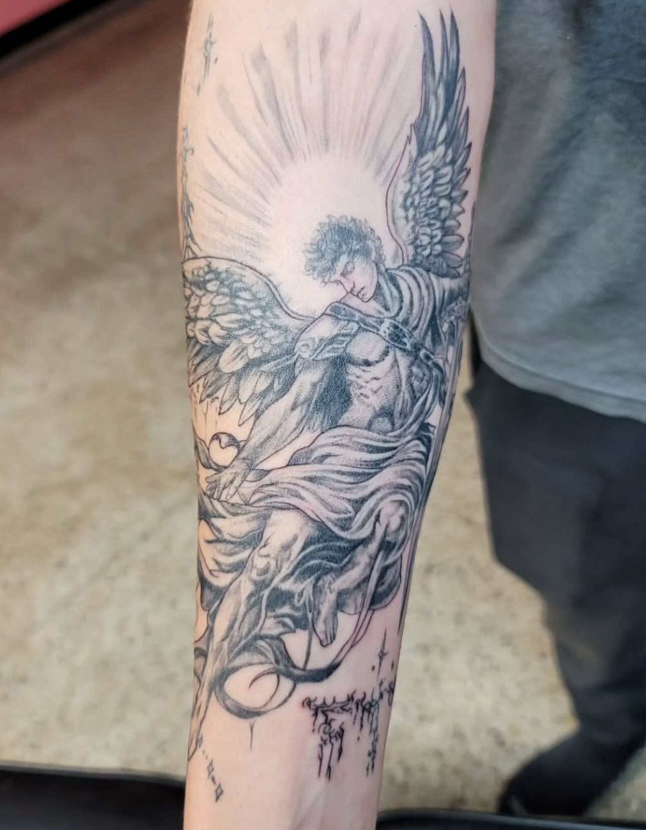 Angel black and grey tattoo on the forearm by Mary Lefeau