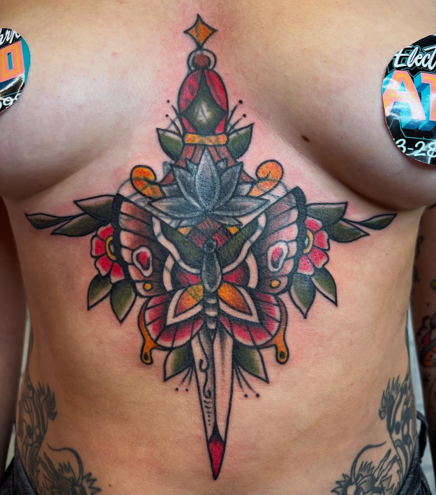 Flower and dagger American traditional tattoo on the chest by Brandi ⛓, Detroit, Michigan
