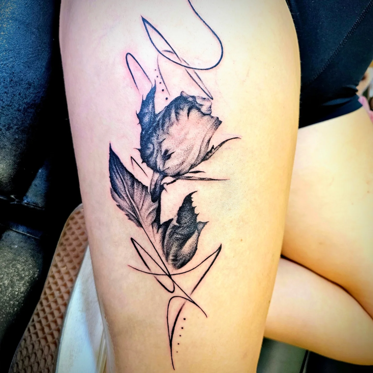 Rose black and grey tattoo on the thigh by Drew King