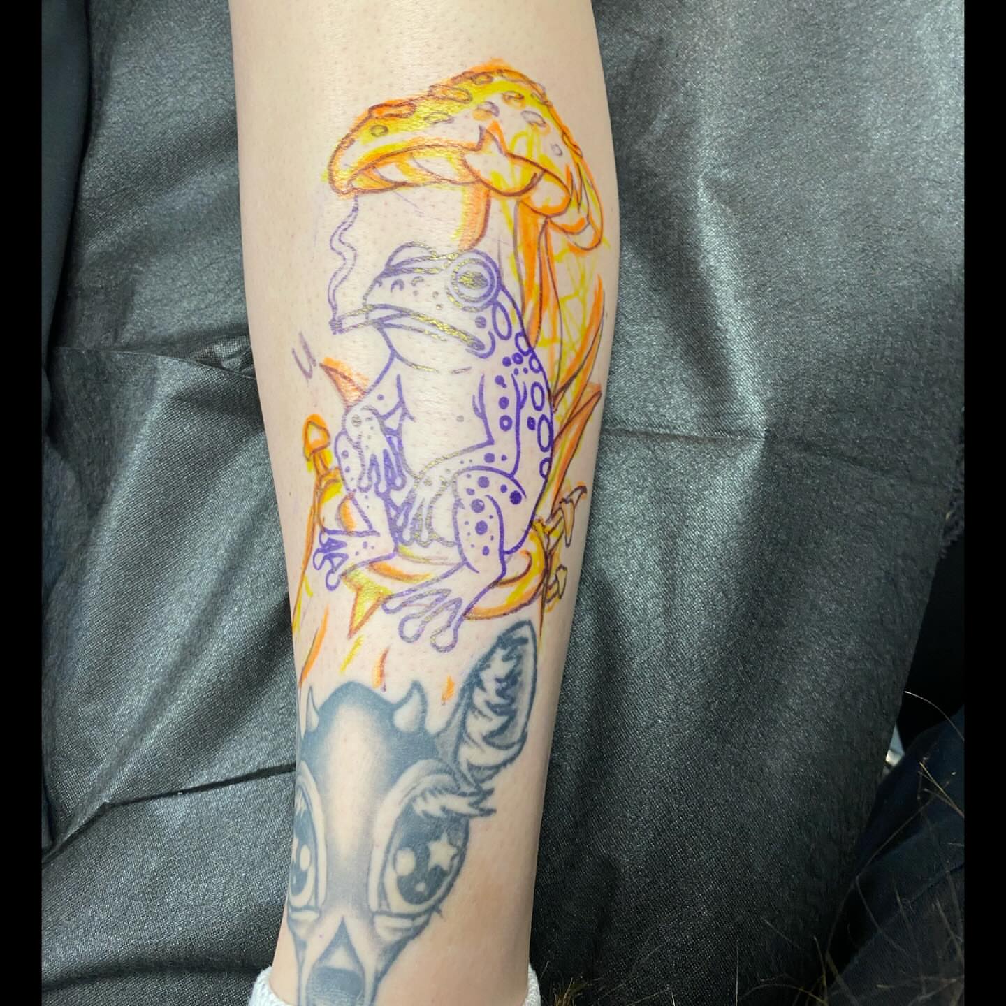 Frog with mushroom hat dotwork tattoo on the forearm by Shelby Warren