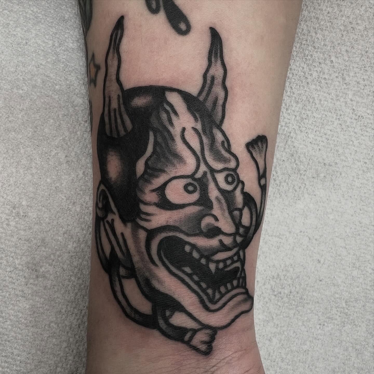 Demon mask black and grey tattoo on the forearm by π³πππ πΆπππππ