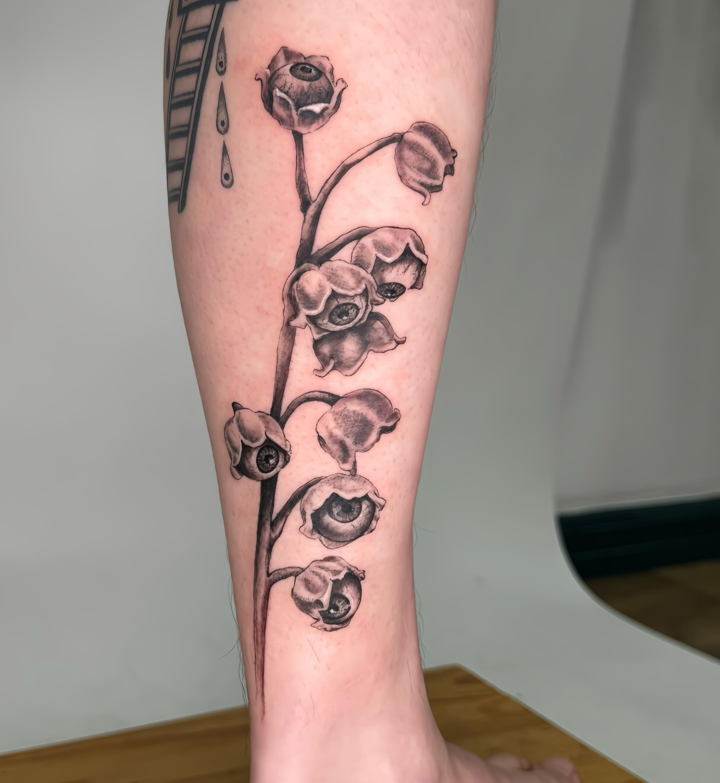 Flowers black and grey tattoo on the forearm by Tiffany