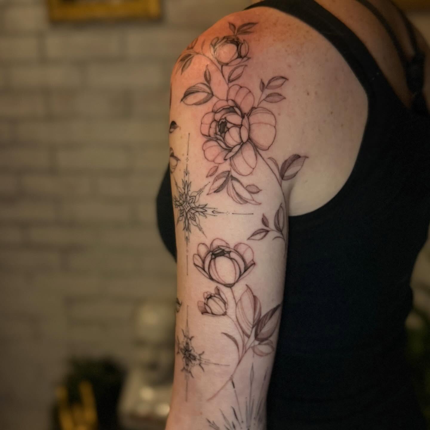 Floral bouquet realism tattoo on the upper arm by ❀ Moo, Mount Laurel, New Jersey