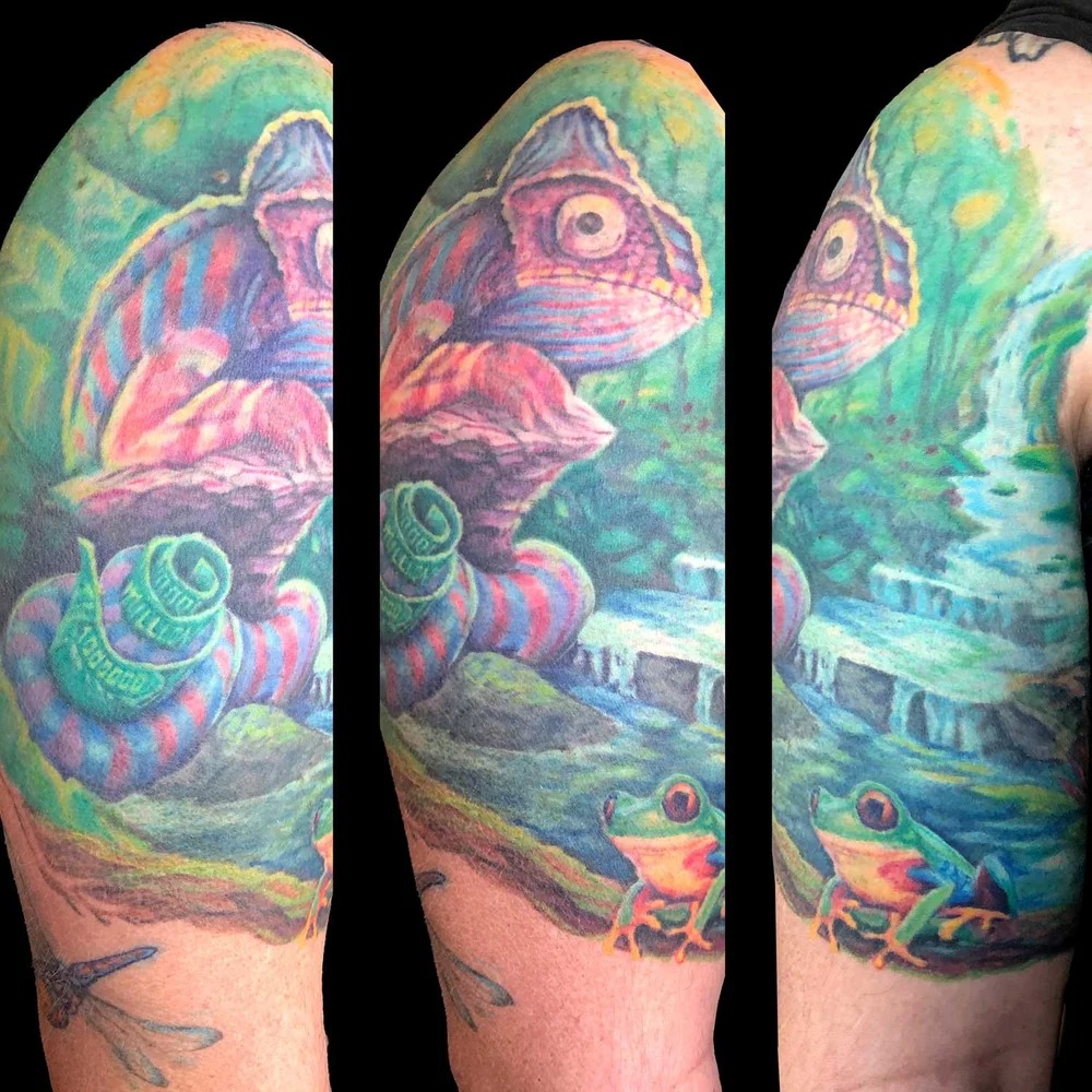 Chameleon and frogs in jungle watercolor tattoo on the upper arm by Dharm, Denver, Colorado