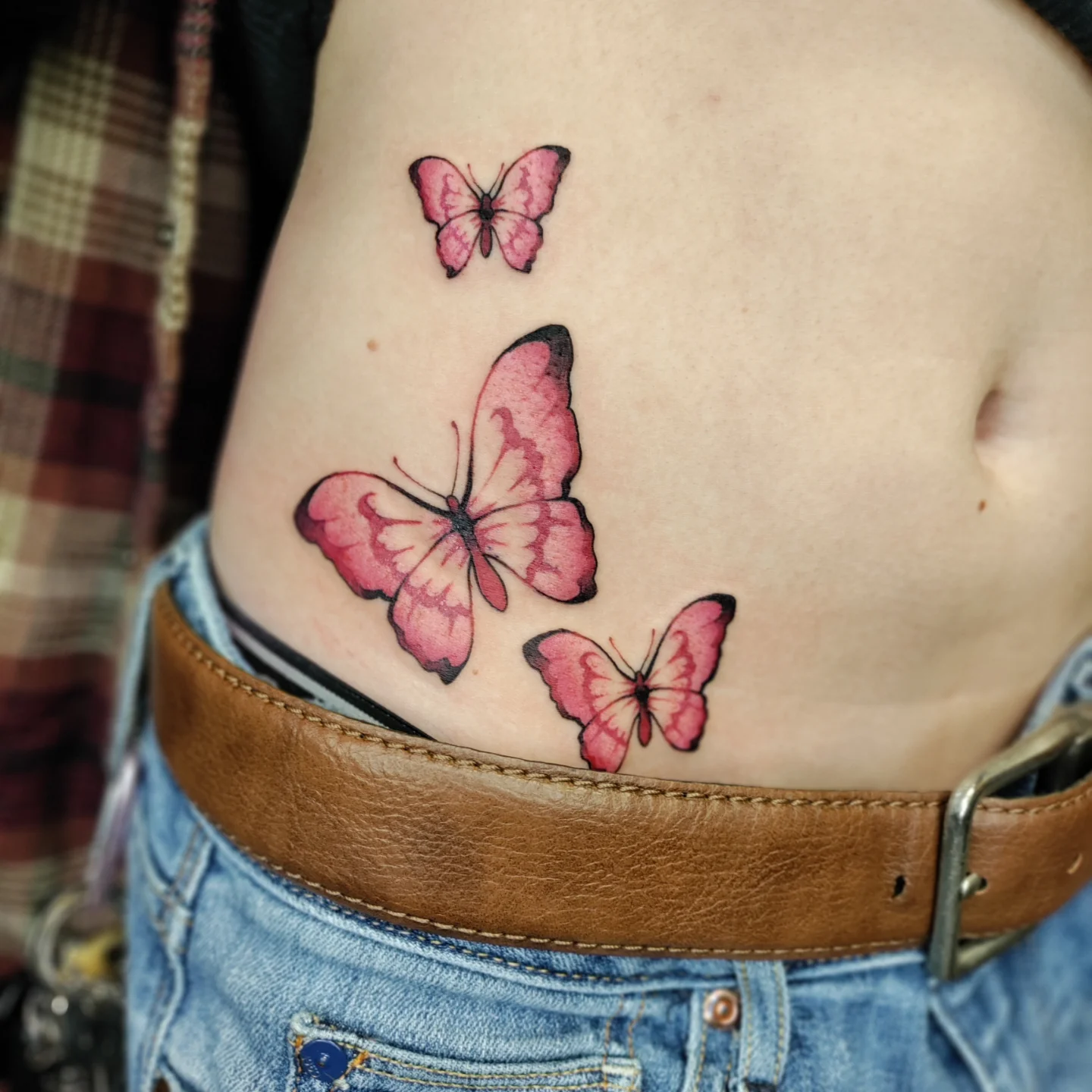 Butterflies watercolor tattoo on the ribs by Kennedy Jones, Lee's Summit, Missouri