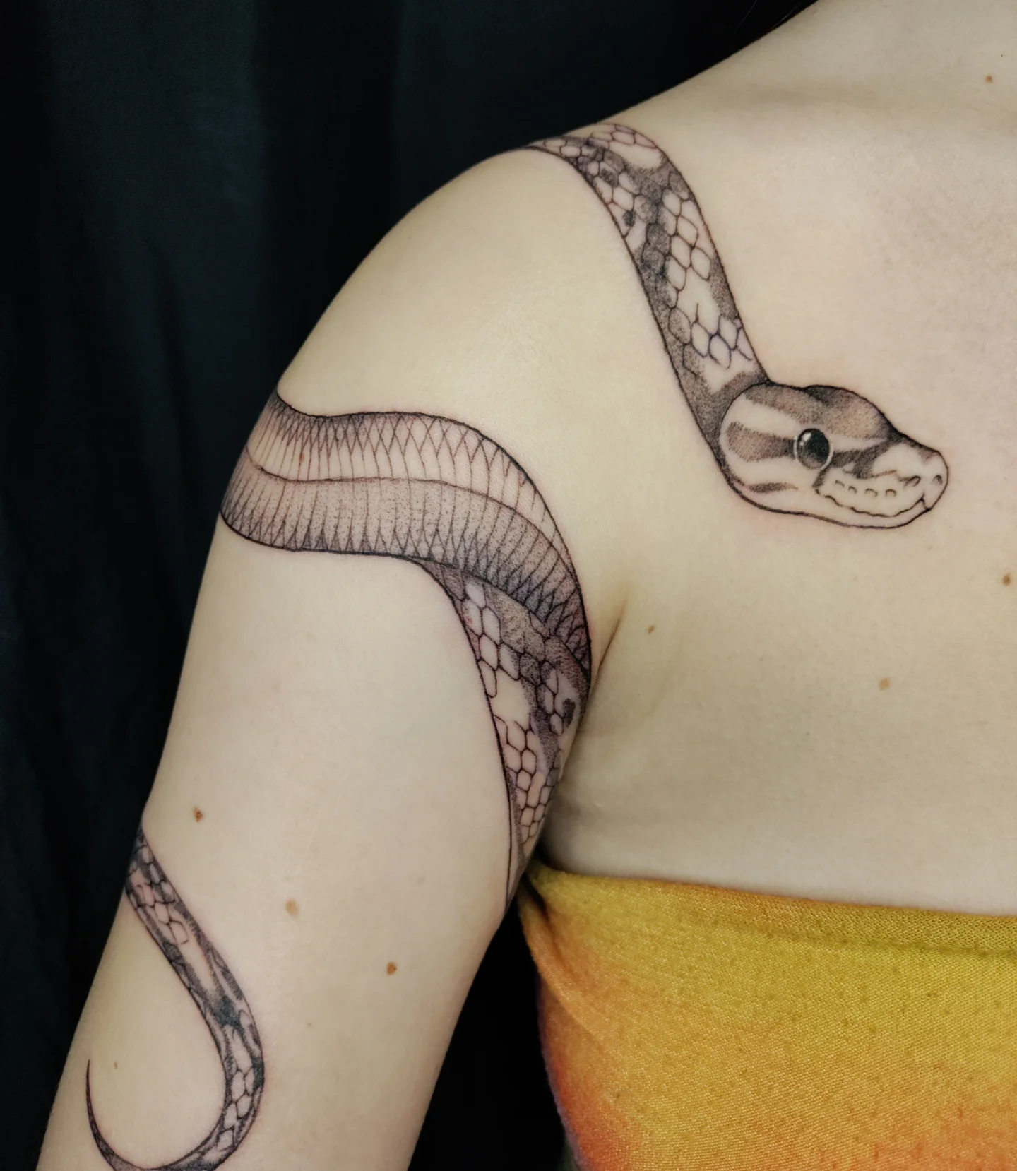 Snake black and grey tattoo on the shoulder by Kennedy Jones, Lee's Summit, Missouri