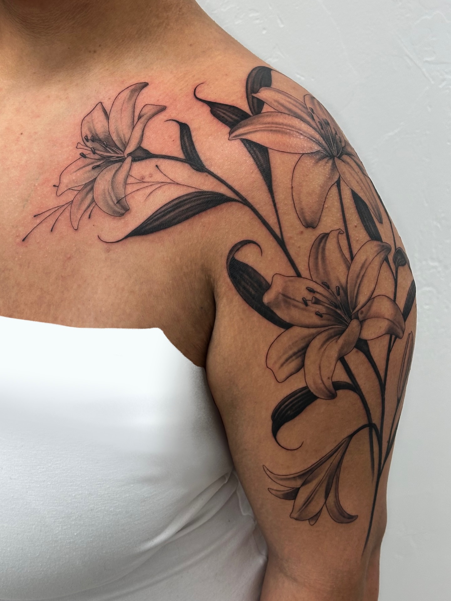 Lilies black and grey tattoo on the shoulder by Winters Ashurst - St. George tattoo artist